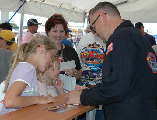 Air Force Reserve Command "Smoke-N-Thunder" jet car driver William Braack signs autographs for the crowd during the Barksdale Air Show Saturday, May 13. (Photo by Tech. Sgt. Sherri Savant)