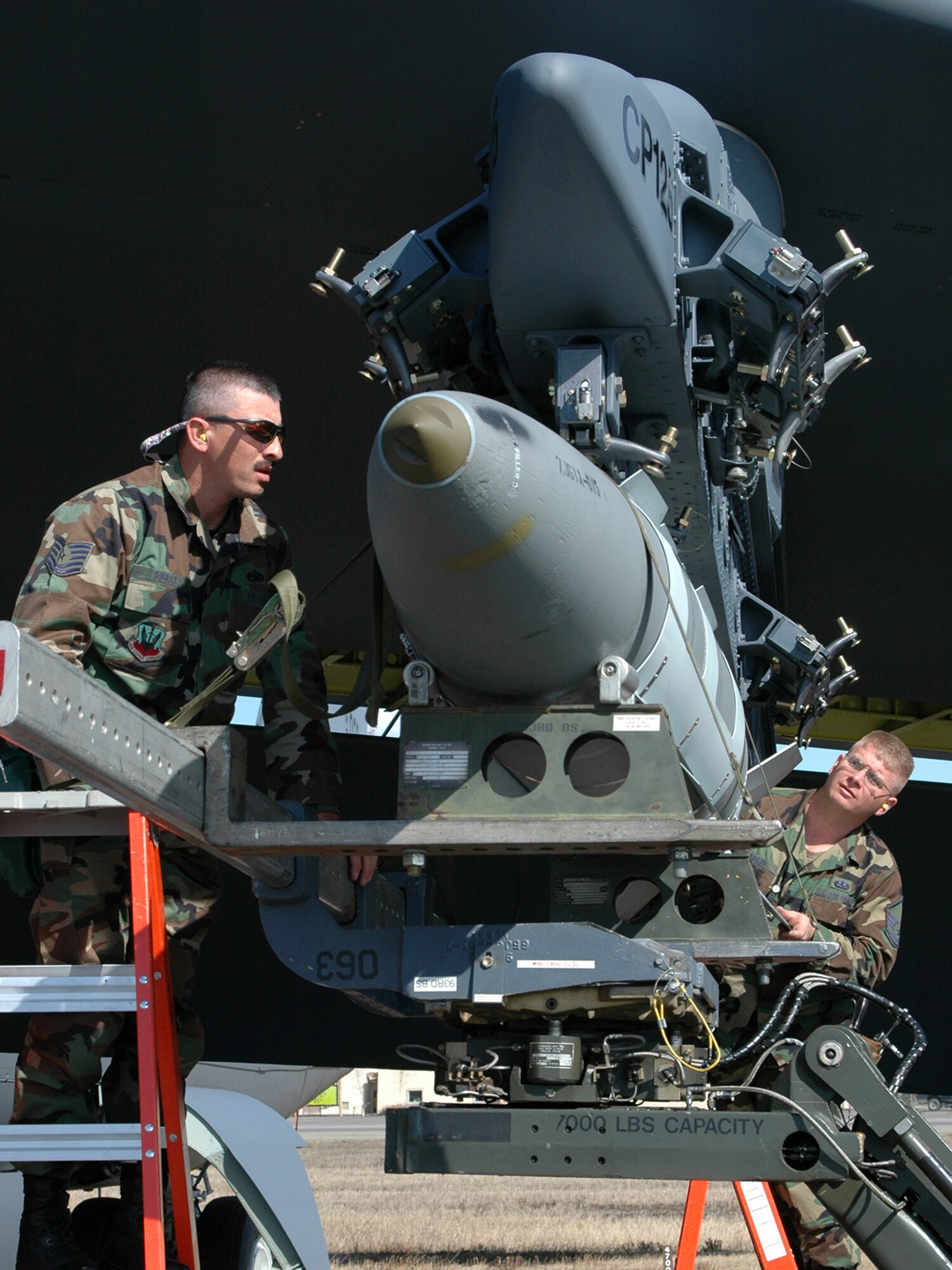 Tech. Sgt. Michael Pierce and Master Sgt. Ben Dorsey, 917th Aircraft Maintenance Squadron weapons loaders, load a 2000-pound bomb on a B-52 to be dropped at the range during RED FLAG - Alaska 06-2 (Photo by Tech Sgt. Jeff Walston).