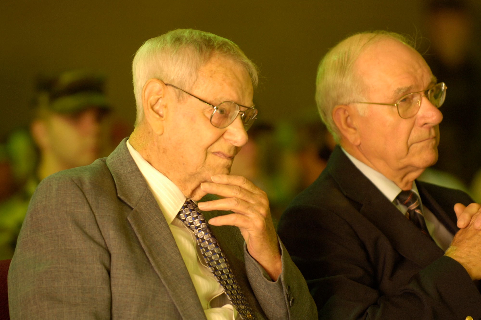 Former Chief Master Sergeants of the Air Force Paul W. Airey and Sam Parish listen to opening remarks at a ceremony dedicating the former 319th Processing Center in Chief Airey's honor at Lackland Air Force Base, Texas, on Wednesday, June 14. The building was one of nine training facilities dedicated to nine enlisted Air Force heroes who have served from World War II to present-day operations in the war on terrorism. The ceremony was part of a three-day event to honor the 60th anniversary of basic military training. (U.S. Air Force photo/Master Sgt. D. Scott Wagers)