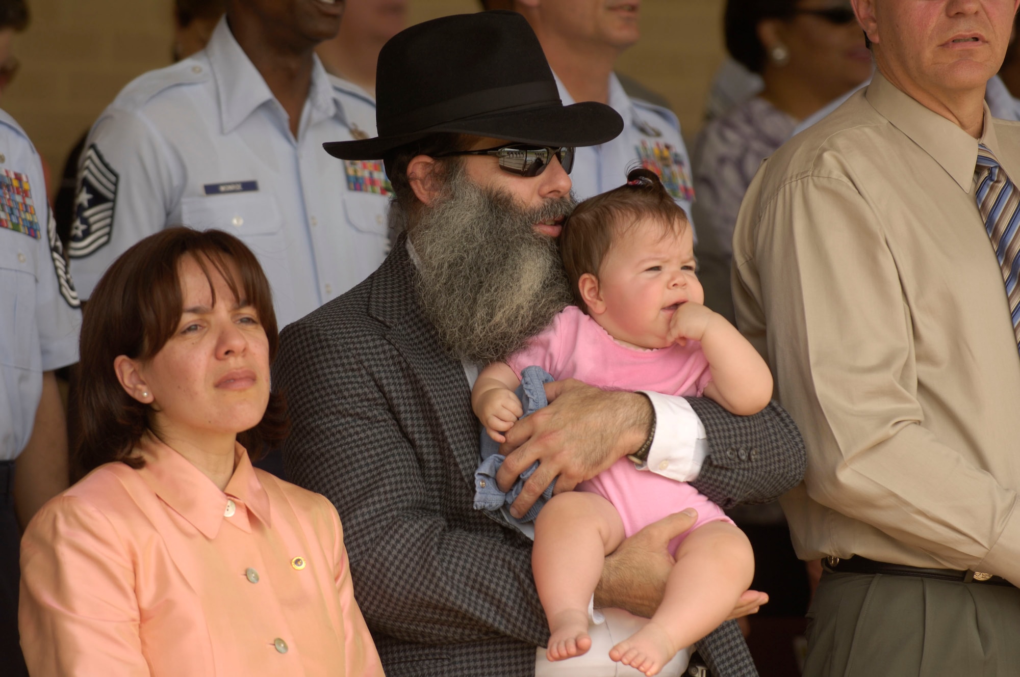 David, Alison and Miriam Jacobsen witness a Basic Military Training Memorialization Ceremony at Lackland Air Force Base, Texas, on Wednesday, June 14, that memorialized Airman 1st Class Elizabeth Jacobsen and eight other enlisted heroes. Several hundred people witnessed the ceremony that dedicated nine training facilities in honor of nine enlisted heroes who have served from World War II to present-day operations in the war on terrorism. The ceremony was part of a three-day event to honor the 60th anniversary of basic military training. (U.S. Air Force photo/Master Sgt. D. Scott Wagers)
