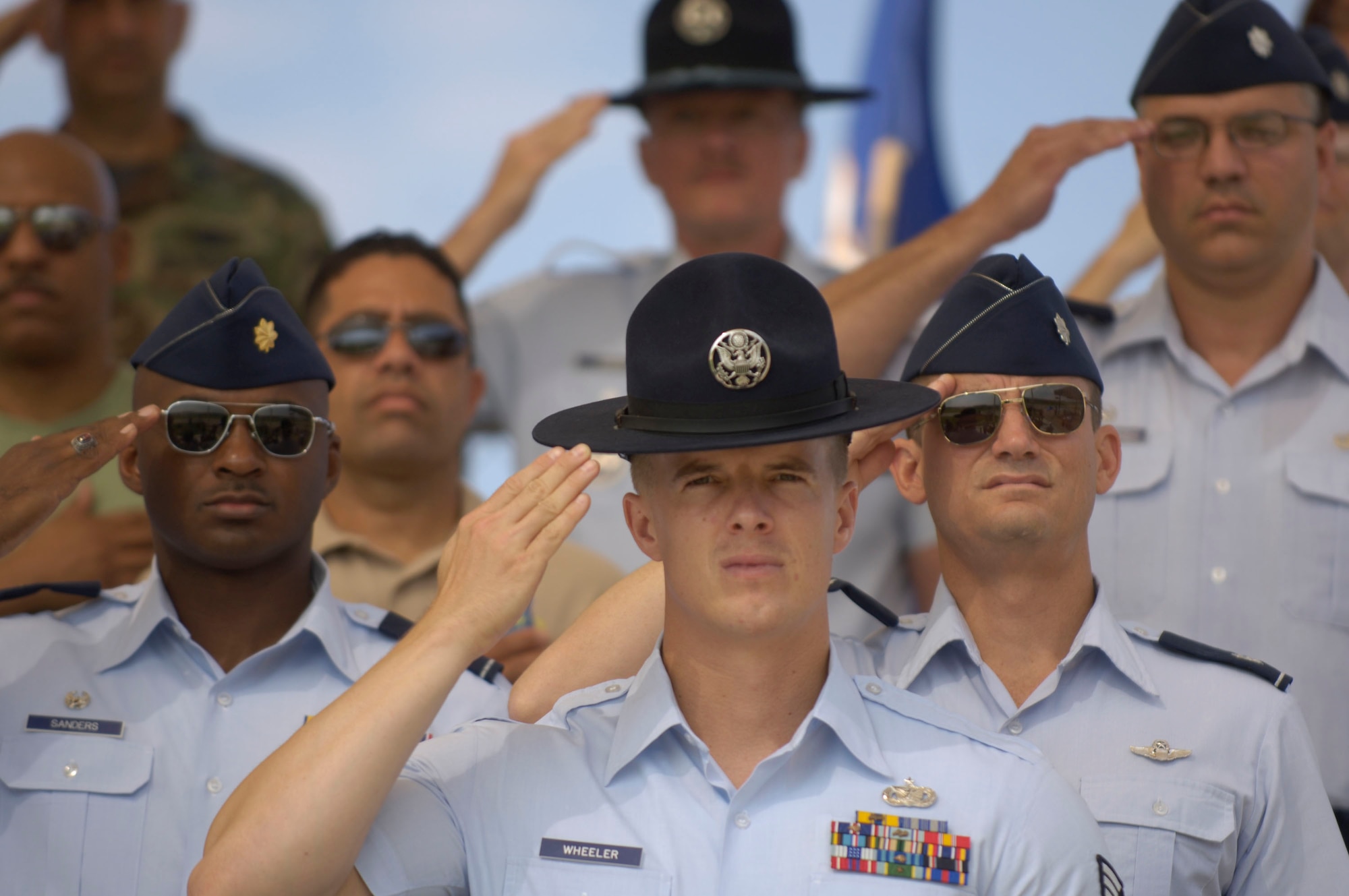 Airmen render a salute during the National Anthem at the Basic Military Training Memorialization Ceremony on Lackland Air Force Base, Texas, on Wednesday, June 14. The ceremony included the dedication of nine training facilities in honor of nine enlisted heroes who have served from World War II to present-day operations in the war on terrorism. (U.S. Air Force photo/Master Sgt. D. Scott Wagers)