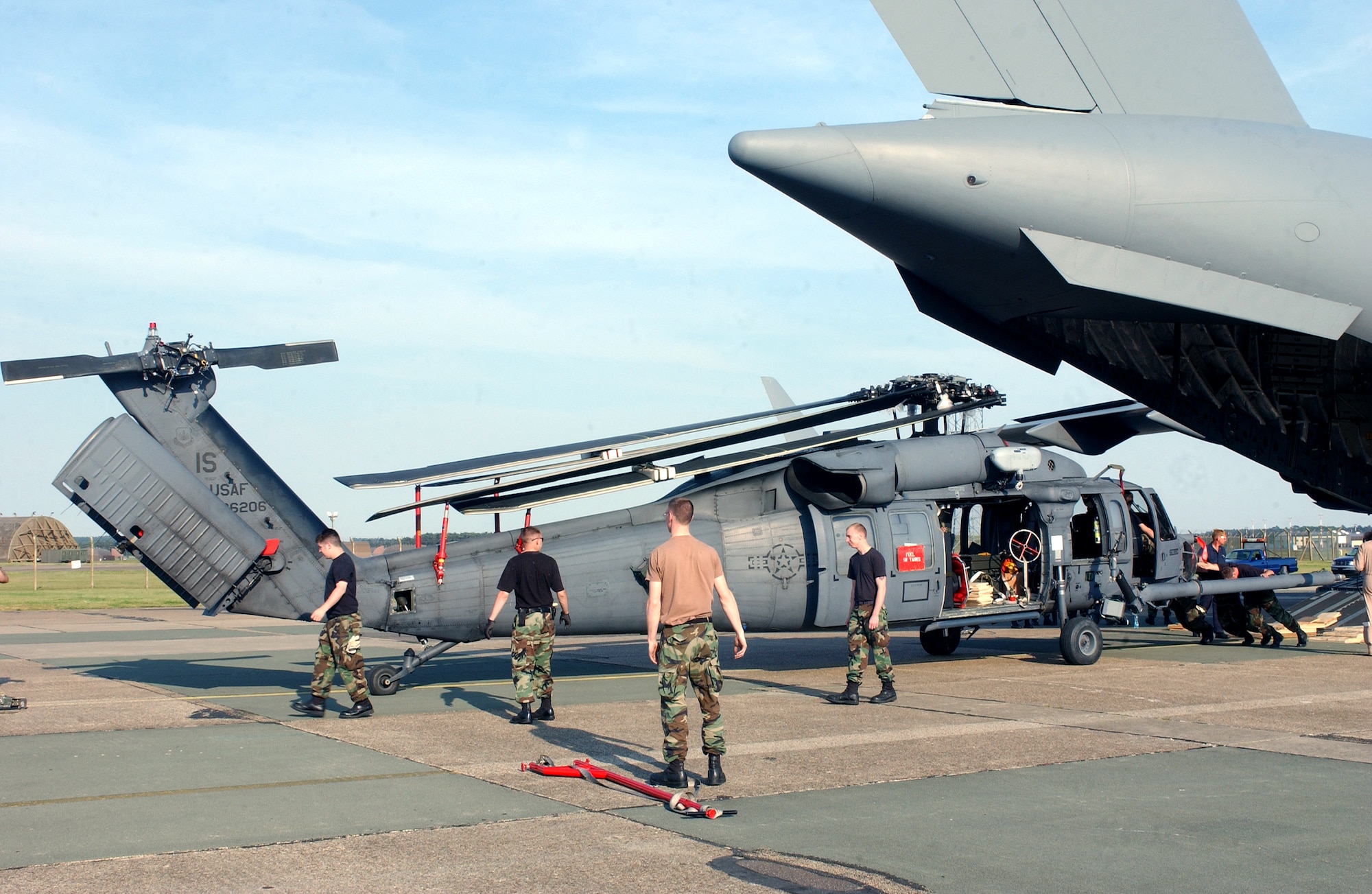 Airmen help unload an HH-60G Pave Hawk helicopter from a C-17 Globemaster III at Royal Air Force Lakenheath, England, on Monday, June 12. The helicopters are being reassigned to RAF Lakenheath from Naval Air Station Keflavik, Iceland. (U.S. Air Force photo)
