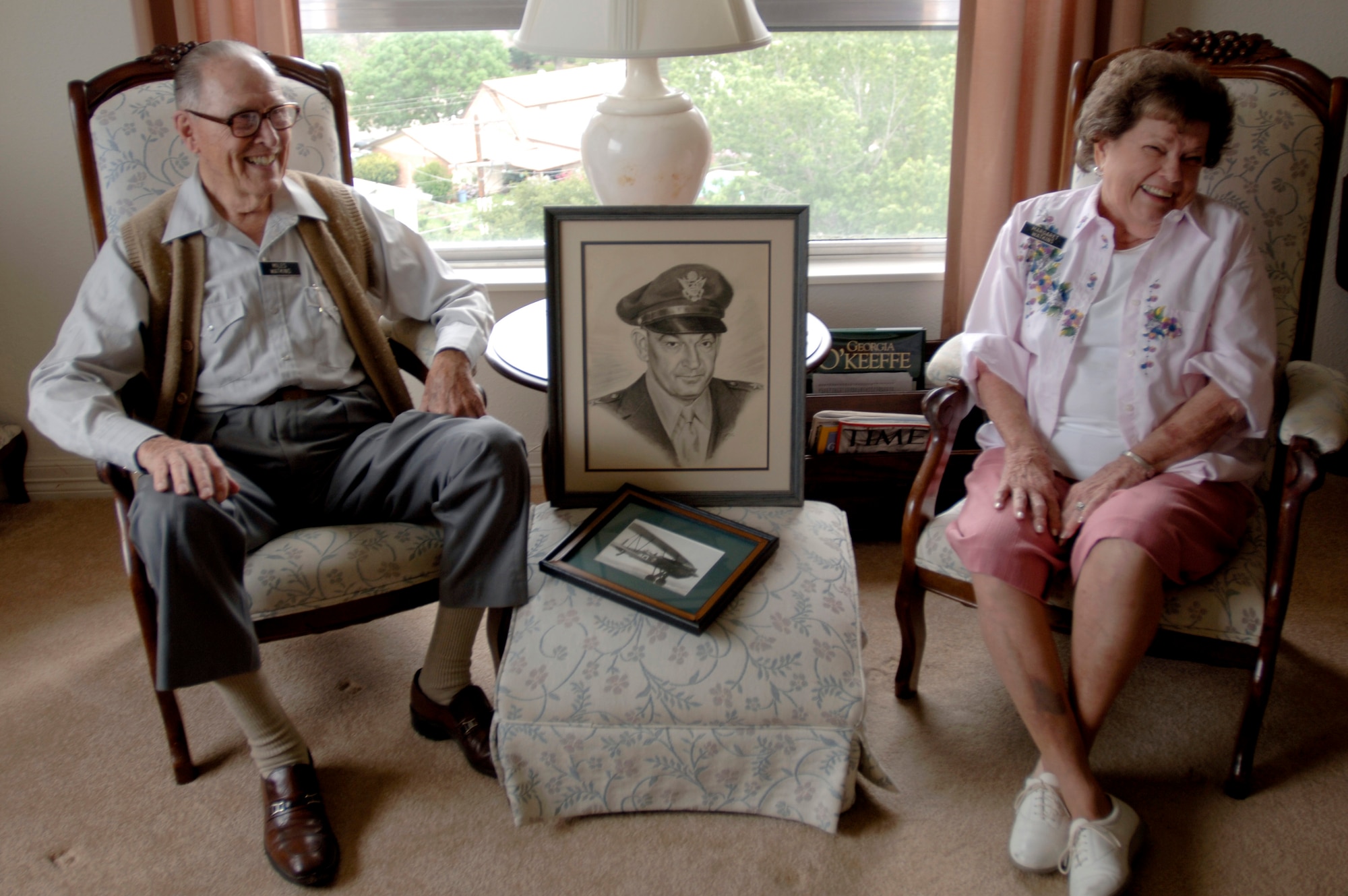 Margaret Ramey Watkins and her husband, retired Air Force Lt. Col. Miles Watkins, sit with a portrait of her father, Brig. Gen. Howard K. Ramey. General Ramey was a founding member of the Order of Daedalians, a fraternal order of military pilots.  (U.S. Air Force photo/Tech. Sgt. Cecilio M. Ricardo Jr.)