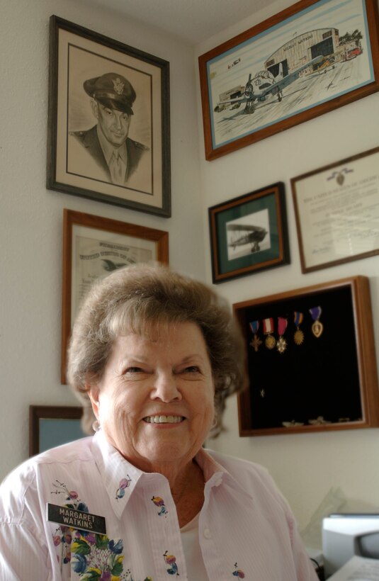 Margaret Ramey Watkins sits beneath a portrait of her father, Brig. Gen. Howard K. Ramey, at her home in San Antonio. General Ramey was a founding member of the Order of Daedalians, a fraternal order of military pilots. (U.S. Air Force photo/Tech. Sgt. Cecilio M. Ricardo Jr.)