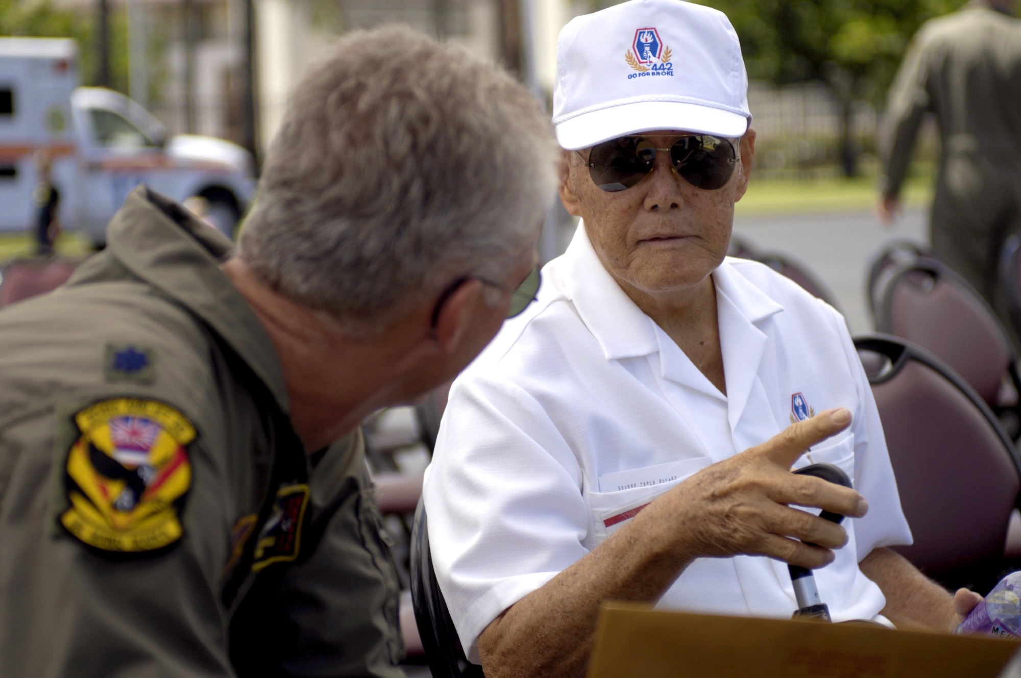 Lt. Col. Gerry Mansell talks to Yoshikatsu Maruo after a C-17 Globemaster III arrival ceremony at Hickam Air Force Base, Hawaii, on Wednesday, June 14. Colonel Mansell is with the Hawaii Air National Guard's 204th Airlift Squadron. Mr. Maruo is a veteran from the 442nd Combat Regimental Team. The aircraft "Spirit of 'Go for Broke'" is named in honor of the 442nd RCT. (U.S. Air Force photo/Tech. Sgt. Shane A. Cuomo) 