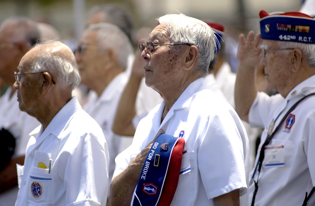 Veterans from the 442nd Regimental Combat Team stand for the National Anthem during a C-17 Globemaster III arrival ceremony at Hickam Air Force Base, Hawaii, on Wednesday, June 14. The "Spirit of 'Go for Broke'" is named in honor of the 442nd RCT. Comprised of 3,800 Japanese Americans, the unit fought with distinction during World War II in North Africa and Europe, becoming one of the most highly decorated units in the history of the U.S. military. (U.S. Air Force photo/Tech. Sgt. Shane A. Cuomo) 
