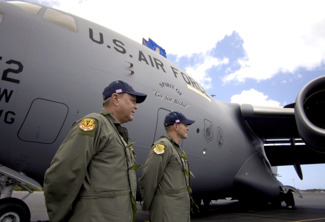 Brig. Gen. Peter S. Pauling and Col. William Changose listen to the blessing of a C-17 Globemaster III during its arrival ceremony at Hickam Air Force Base, Hawaii, on Wednesday, June 14. The aircraft "Spirit of 'Go for Broke'" is named in honor of the 442nd Regimental Combat Team. General Pauling is commander of the Hawaii Air National Guard's 154th Wing. Colonel Changose is the 15th Airlift Wing commander. (U.S. Air Force photo/Tech. Sgt. Shane A. Cuomo)