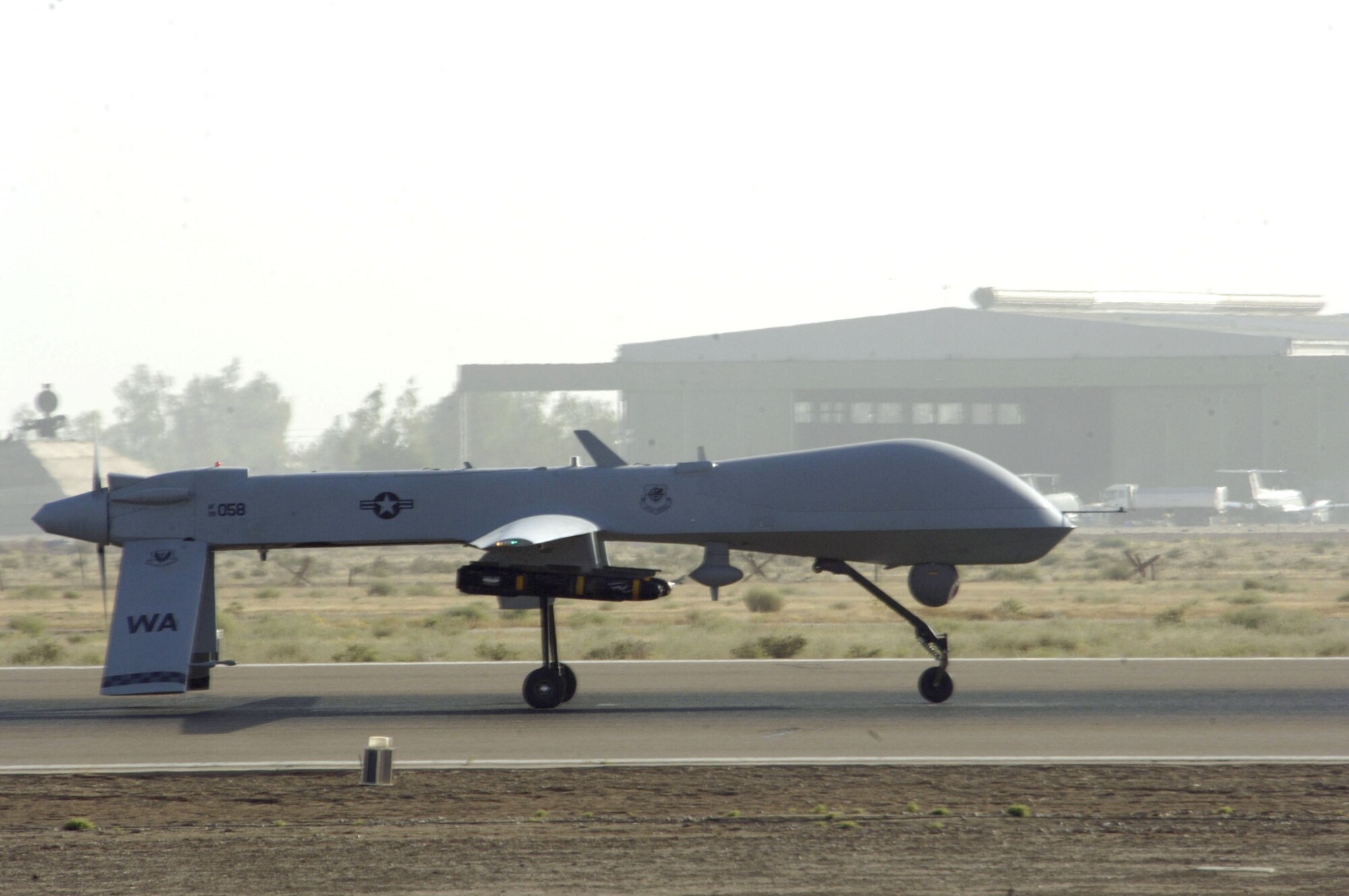 An MQ-1 Predator unmanned aerial vehicle taxis down the runway at Balad Air Base, Iraq, on Wednesday, June 14. The Predator can employ two laser-guided Hellfire anti-tank missiles. (U.S. Air Force photo/Airman 1st Class Andrew Oquendo) 
