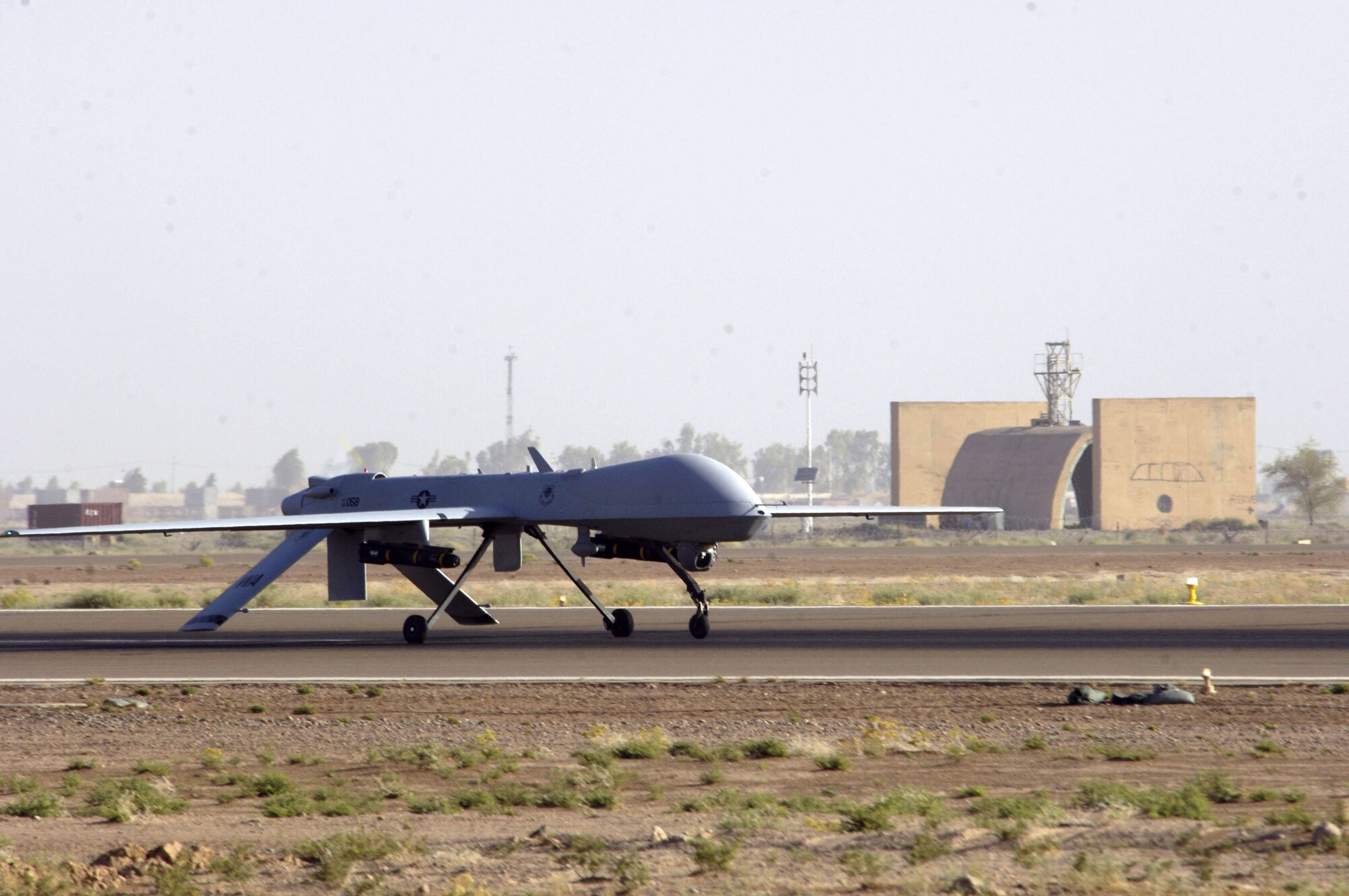 An MQ-1 Predator unmanned aerial vehicle taxis down the runway at Balad Air Base, Iraq, on Wednesday, June 14. The Predator can employ two laser-guided Hellfire anti-tank missiles. (U.S. Air Force photo/Airman 1st Class Andrew Oquendo) 
