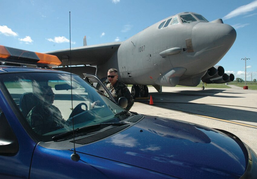 Master Sgt. Keith Kanyuh (in vehicle), 5th Aircraft Maintenance Squadron production expediter, relays maintenance information with Master Sgt. Michael Bjorn, 5th AMXS production superintendent at the alternate parking area Monday. For the flightline production team, a shift consists of one production superintendent and two expediters whose office is basically on the flightline. They monitor radios and communicate with the technicians who are reviewing all the systems that make Minot’s B-52H Stratofortresses fly. All aspects of maintenance are constantly being overseen and prioritized by the team. (U.S. Air Force photo by Airman 1st Class Ross Tweten)