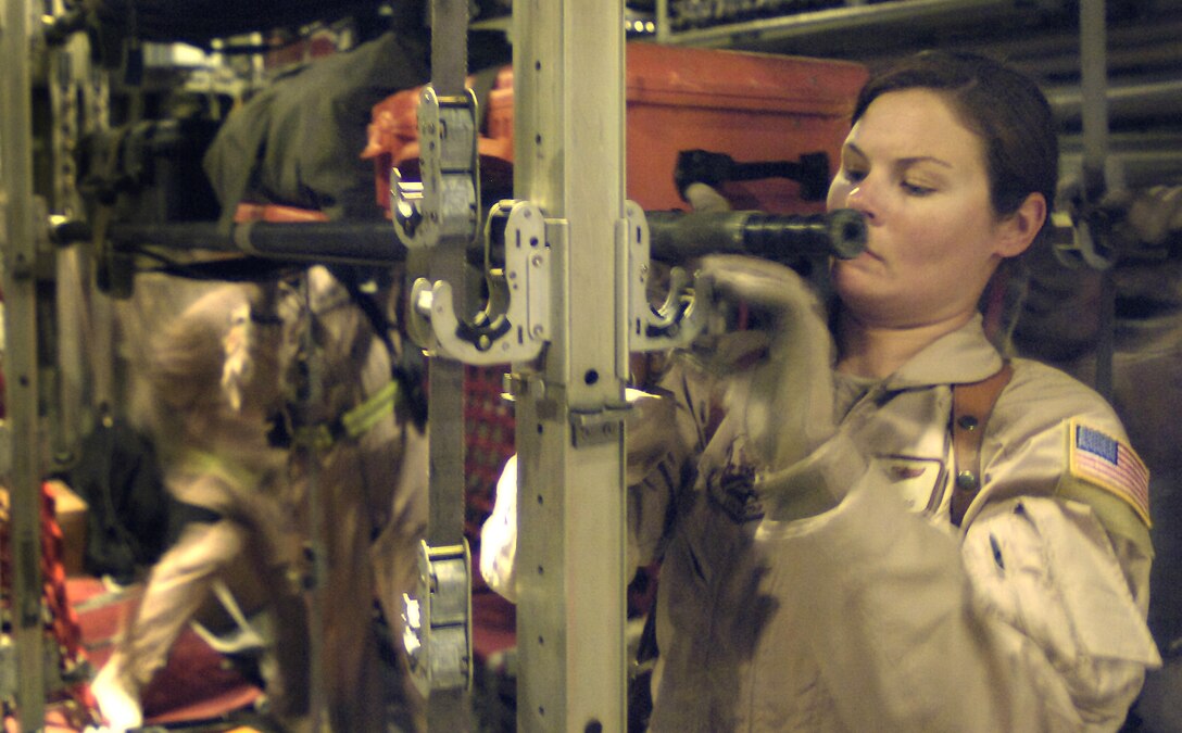 Staff Sgt. Jody Gragg locks down a litter of medical equipment aboard a C-130 Hercules as she helps reconfigure the aircraft for an aeromedical evacuation mission from Bagram Air Base, Afghanistan, on Thursday, June 8. Sergeant Gragg is assigned to the 455th Expeditionary Aeromedical Evacuation Flight. She is deployed from the 43rd Aeromedical Evacuation Squadron at Pope Air Force Base, N.C. (U.S. Air Force photo/Senior Airman Brian Ferguson) 