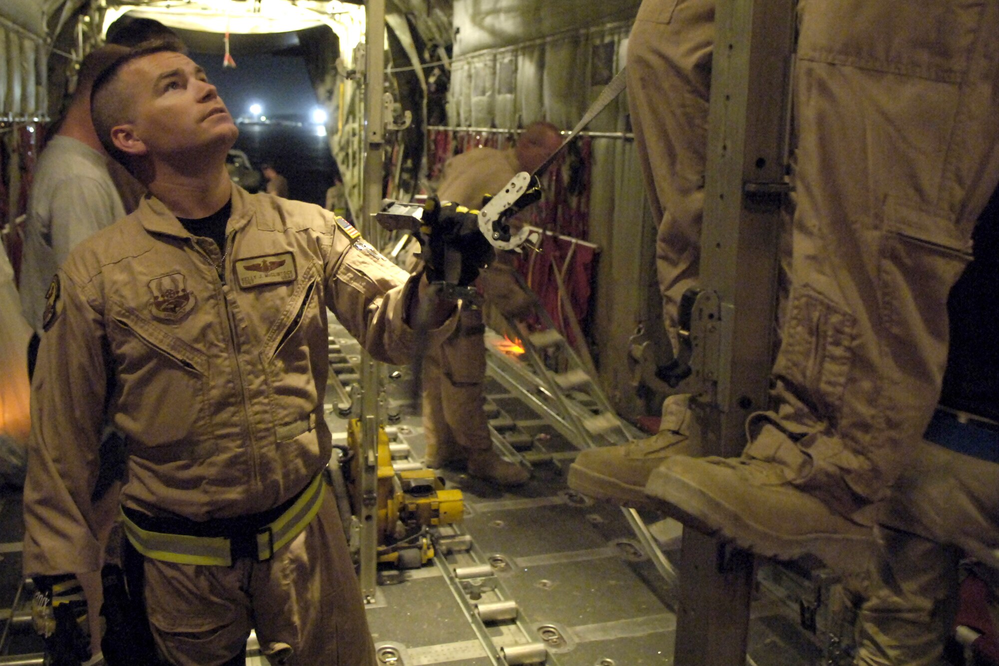 Tech. Sgt. Kelly McClintock helps reconfigure a C-130 Hercules for an aeromedical evacuation mission from Bagram Air Base, Afghanistan, on Thursday, June 8. Sergeant McClintock is assigned to the 455th Expeditionary Aeromedical Evacuation Flight. He is deployed from the Air National Guard's 146th Aeromedical Evacuation Squadron at Channel Island, Calif. (U.S. Air Force photo/Senior Airman Brian Ferguson)