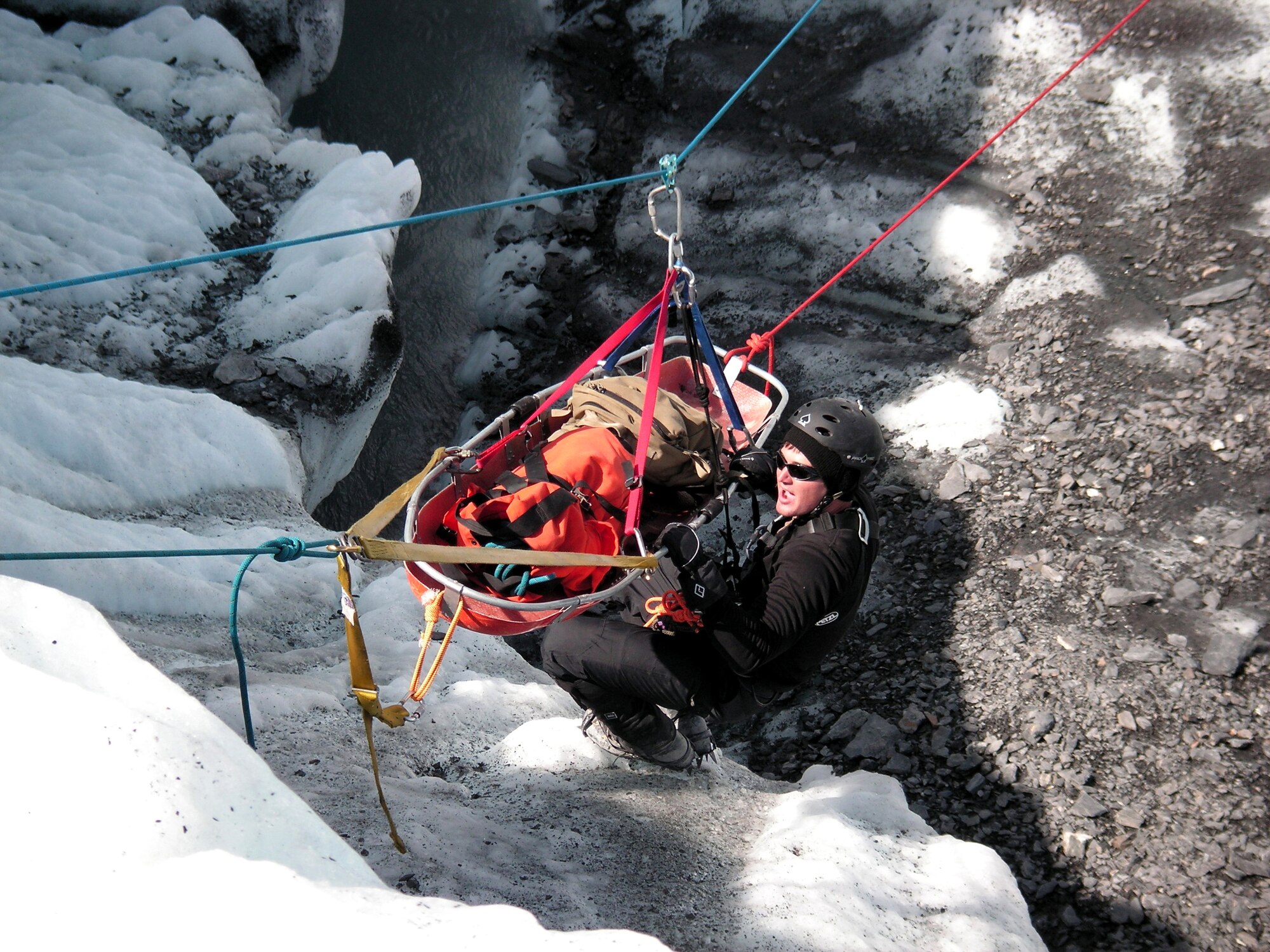 A pararescuemen uses a pulley system with a carriage to rescue a simulated victim from a glacier near Eielson Air Force Base, Alaska, as part of Exercise Northern Edge 2006. (U.S. Air Force photo/Maj. Andrew Reisenweber) 
