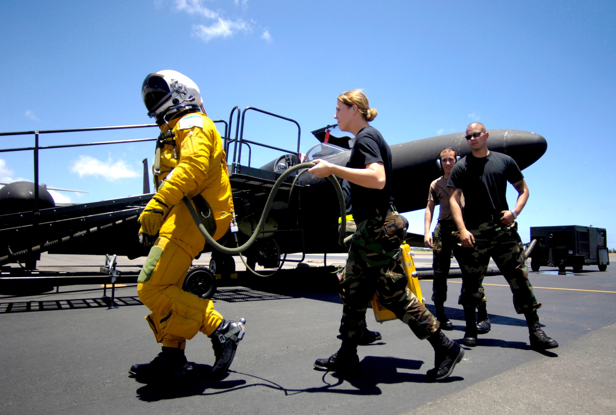 A pilot from the 99th Reconnaissance Squadron at Beale Air Force Base, Calif., walks to his U-2 Dragon Lady at Hickam AFB, Hawaii, on Tuesday, June 13. The aircraft is en route to South Korea. U-2s are undergoing a $1.5 billion upgrade. Cockpit instruments will be modernized with full-color displays that replace gauges and dials with state-of-the-art, touch-screen technology. (U.S. Air Force photo/Tech. Sgt. Shane A. Cuomo)