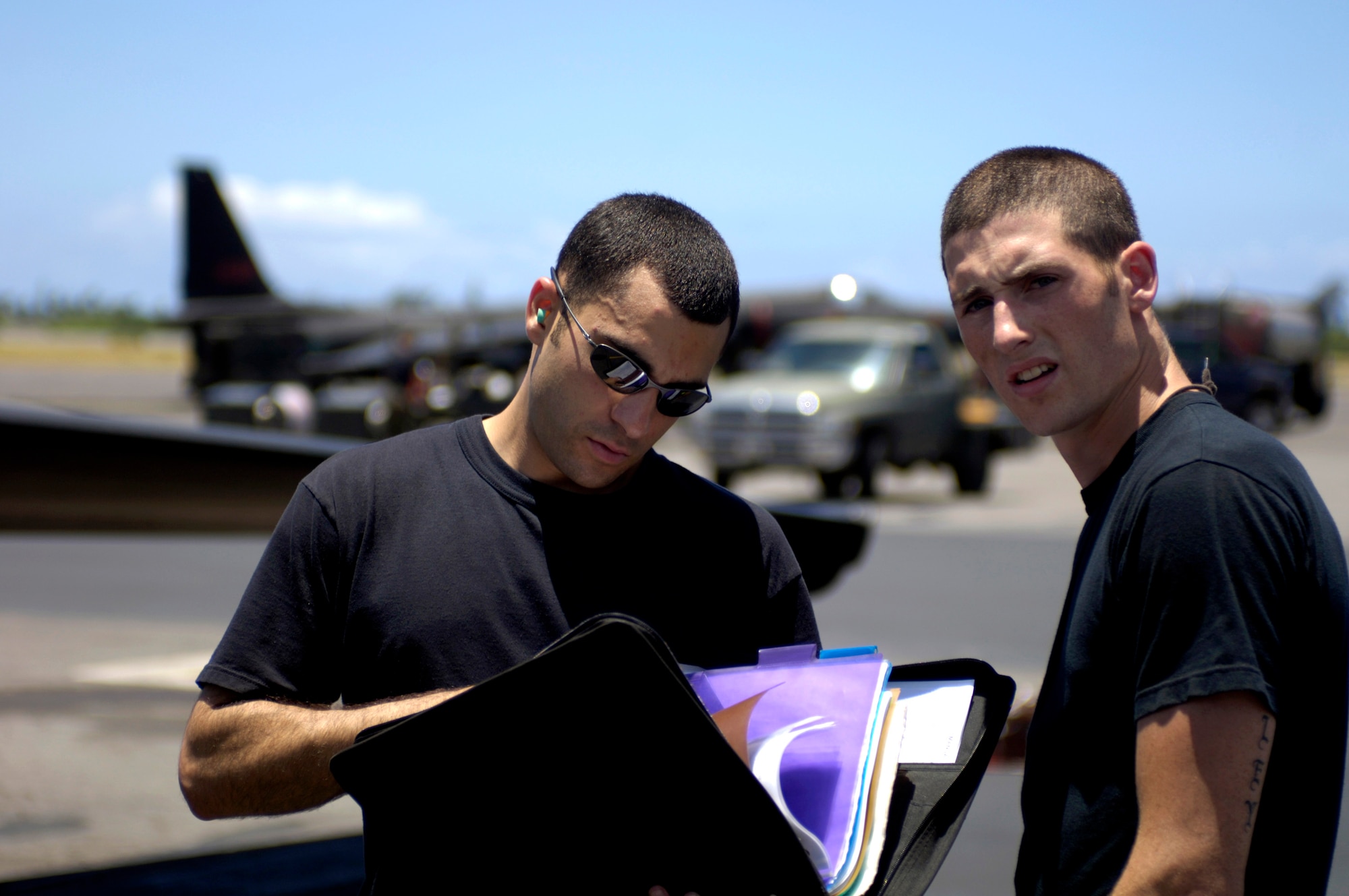 Staff Sgt. Andrew Di Betta and Airman 1st Class Michael Viel review a maintenance log for a U-2 Dragon Lady before it takes off from Hickam Air Force Base, Hawaii, on Tuesday, June 13. The aircraft is en route to South Korea. U-2s are undergoing a $1.5 billion upgrade. Cockpit instruments will be modernized with full-color displays that replace gauges and dials with state-of-the-art, touch-screen technology. Sergeant Di Betta and Airman Viel are crew chiefs from 9th Maintenance Squadron at Beale AFB, Calif. (U.S. Air Force photo/Tech. Sgt. Shane A. Cuomo)