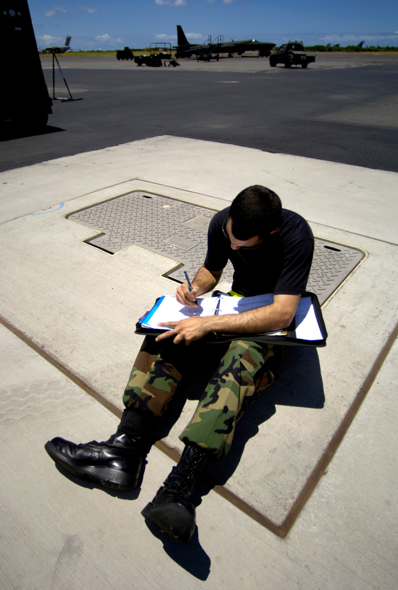 Staff Sgt. Andrew Di Betta annotates his maintenance log for a U-2 Dragon Lady at Hickam Air Force Base, Hawaii, on Tuesday, June 13. The aircraft is en route to South Korea. U-2s are undergoing a $1.5 billion upgrade. Cockpit instruments will be modernized with full-color displays that replace gauges and dials with state-of-the-art, touch-screen technology. Sergeant Di Betta is a crew chief with the 9th Maintenance Squadron at Beale Air Force Base, Calif. (U.S. Air Force photo/Tech. Sgt. Shane A. Cuomo) 
