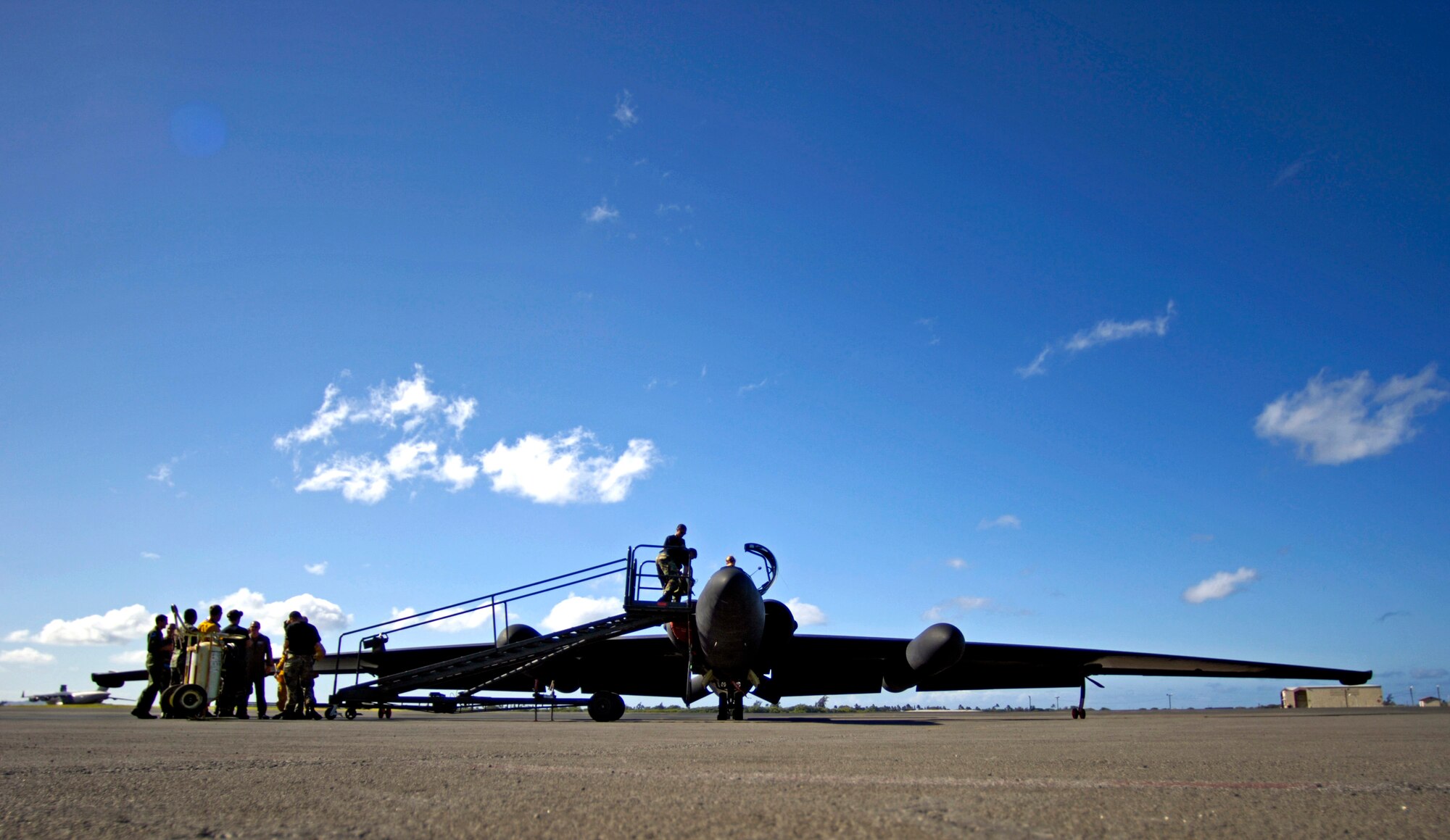 Airmen from the 9th Reconnaissance Wing at Beale Air Force Base, Calif., recover a U-2 Dragon Lady after it landed at Hickam AFB, Hawaii, on Tuesday, June 13. The aircraft is en route to South Korea. U-2s are undergoing a $1.5 billion upgrade. Cockpit instruments will be modernized with full-color displays that replace gauges and dials with state-of-the-art, touch-screen technology. (U.S. Air Force photo/Tech. Sgt. Shane A. Cuomo)
