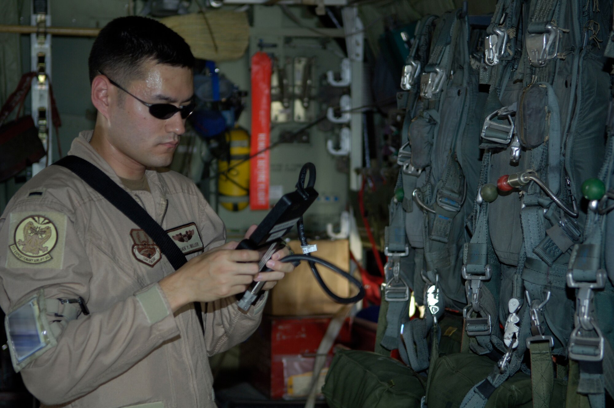 During pre-flight rounds, 2nd Lieutenant Brian Miller, 777th Expeditionary Airlift Squadron pilot, checks the radios on his C-130. The primary mission of the 777th EAS is covoy reduction. (U.S. Air Force Photo by Airman 1st Class Andrew Oquendo)