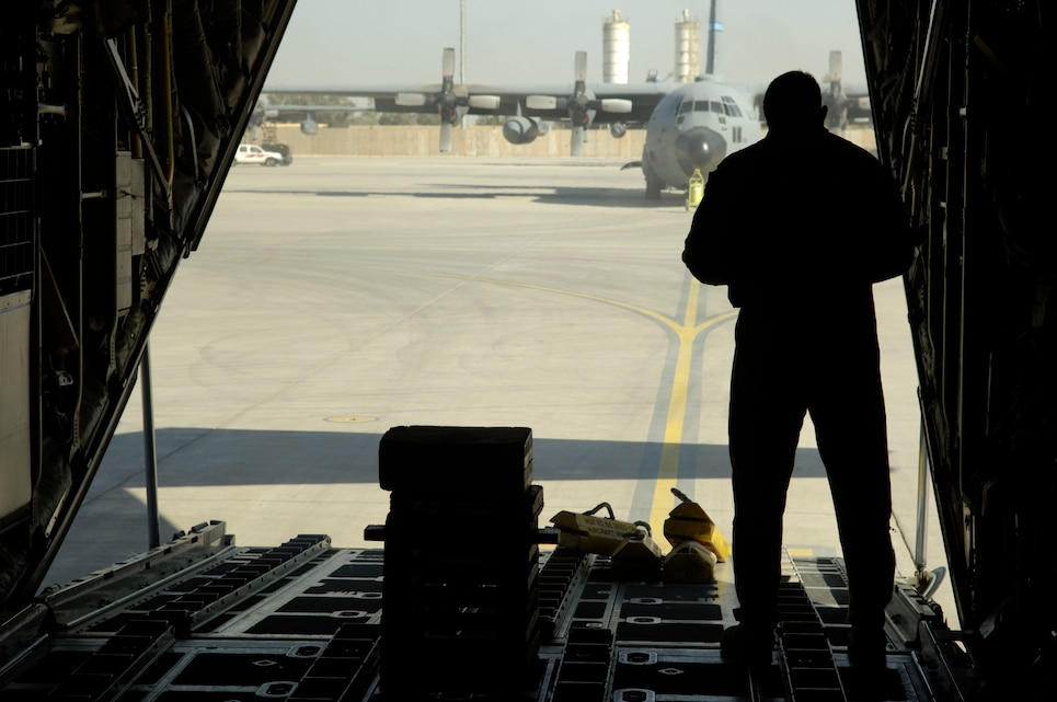 BALAD AIR BASE, Iraq -- A loadmaster assigned to the 777th Expeditionary Airlift Squadron makes final preparations for flight before the C-130 is sealed up for a mission. C-130s began operating here in January, the first time for a Hercules to operate from a foward-deployed location. (U.S. Air Force photo by Airman 1st Class Andrew Oquendo)