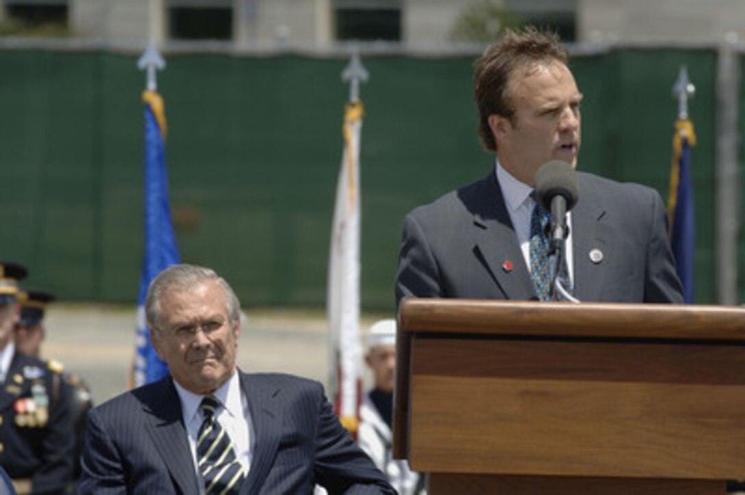 Secretary of Defense Donald H. Rumsfeld listens as the President of the Pentagon Memorial Fund Jim Laychak delivers remarks at the Pentagon Memorial Groundbreaking ceremony on June 15, 2006. The Pentagon Memorial will commemorate the 184 people killed in the Pentagon and on American Airlines Flight 77 on September 11, 2001. Laychak lost his brother David who worked at the Pentagon. 