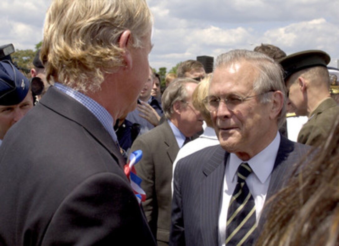 Secretary of Defense Donald H. Rumsfeld (right) talks with family members of the 184 people killed in the Pentagon and on American Airlines Flight 77 on September 11, 2001, after groundbreaking ceremonies for the Pentagon Memorial on June 15, 2006. The memorial will commemorate the 184 people killed in the Pentagon and on American Airlines Flight 77 on Sept. 11, 2001. 