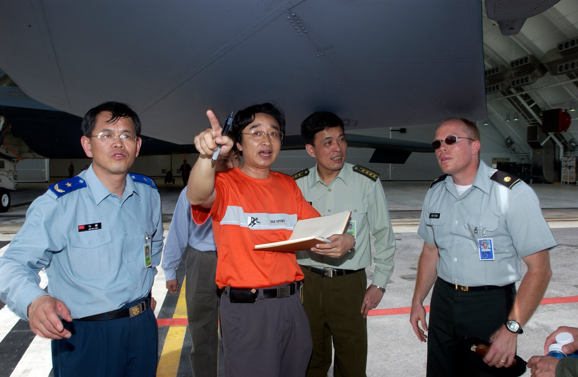 ANDERSEN AIR FORCE BASE, Guam -- Reporters and members of the Chinese foreign observer team ask questions about the F-15, during Valiant Shield '06, from an American representative. Foriegn observers were present from China, Russia, India, Australia, the Republic of Korea, Singapore, and Japan. Valiant Shield begins June 19 and lasts through June 23, and will be conducted in the vicinity of Guam. Valiant Shield focuses on integrated joint training among US military forces. (U.S. Air Force photo by Airman First Class Michael S. Dorus)