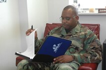 Staff Sergeant Shawn Brown, IDEA program manager, reviews IDEA packages.  The IDEA program is designed to put money in Airmen’s pockets for their ideas to save the Air Force money. (U.S. Air Force photo by Jennifer Brugman)