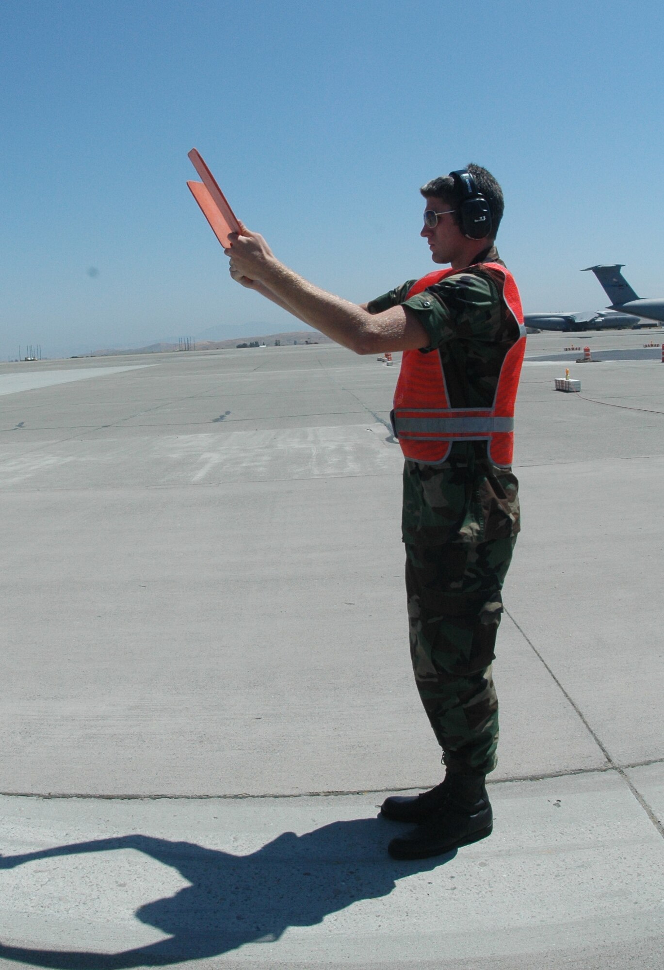 Cadet Aaron Magger marshals out a KC-10 after a quick demonstration of how to communicate with the pilot with hand gestures. Cadet Magger is part of the Rising Sophomore program, which exposes rising Reserve Officers’ Training Corps sophomores to an enlisted perspective of the operational Air Force. (U.S. Air Force photo by Airman 1st Class Tiffany Low)