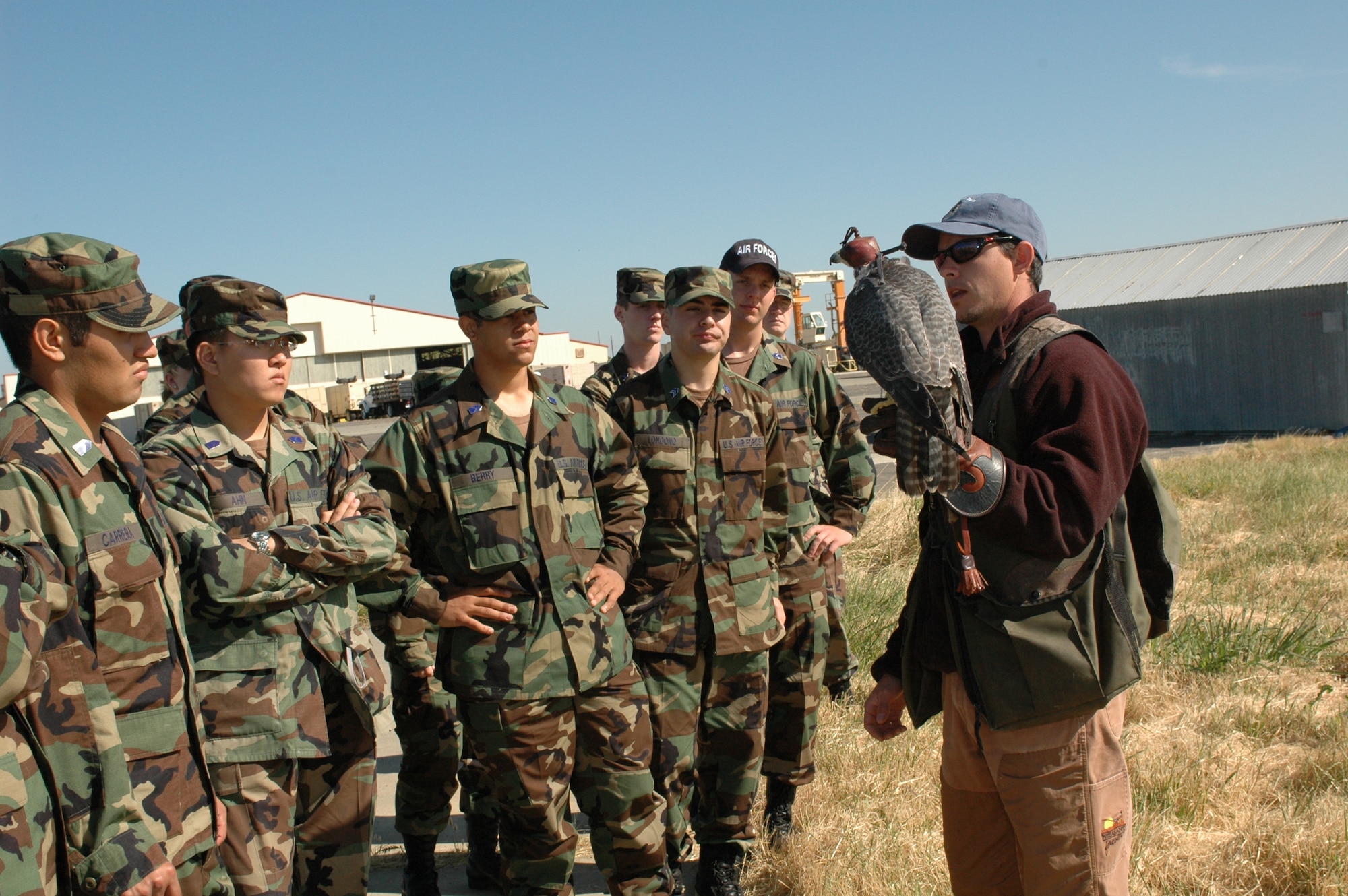 Mr. Mike Bierman [right], a master falconer with the World Bird Sanctuary and caregiver of the falcons on base, explains to cadets how birds like Sonjia help keep the flightline area safe. More than 120 cadets from all over the United States will visit the base in three groups this summer. The first group arrived June 4 and will stay until June 24. (U.S. Air Force photo by Airman 1st Class Tiffany Low)
