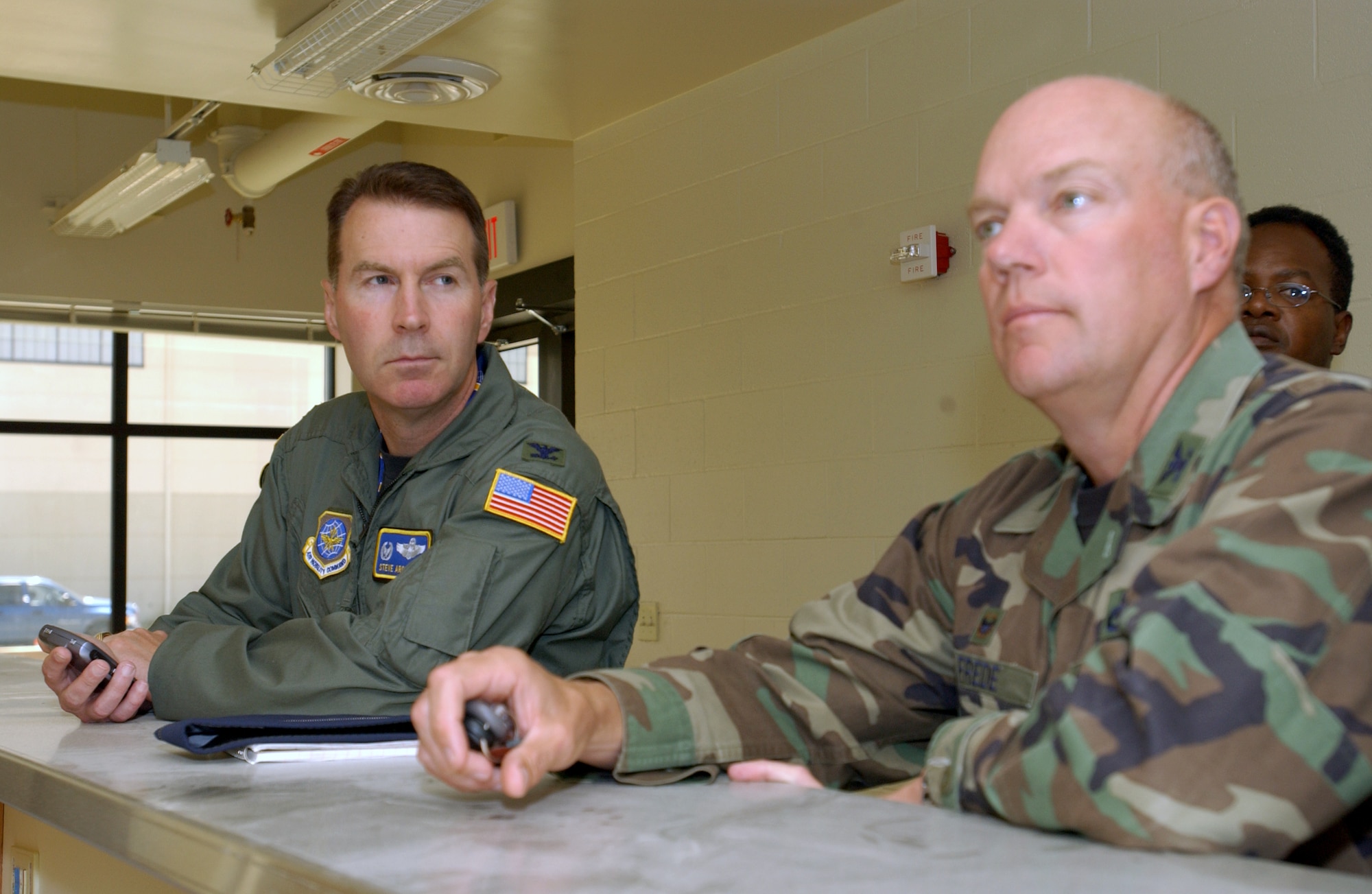 Col. Steve Arquiette, 60th AMW commander, attends a briefing with Col. Keith Frede, 60th Maintenance Group commander. Colonel Frede will relinquish command Monday. (U.S. Air Force photo by Andre Mansour)