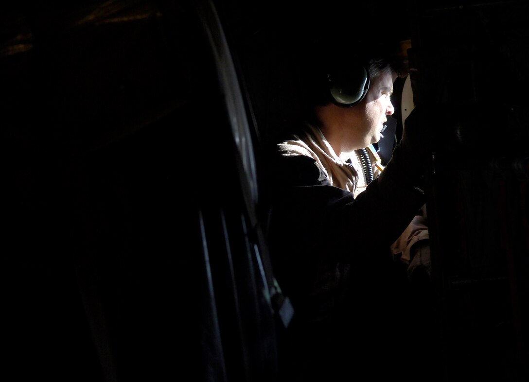 Tech. Sgt. Ken Bishop checks the left side of the aircraft during descent into Forward Operating Base Salerno, Afghanistan, on Saturday, June 10. Sergeant Bishop is a loadmaster for the 774th Expeditionary Airlift Squadron. The squadron is the only U.S. C-130 squadron in Afghanistan, and flies approximately five missions a day providing airlift and airdrops to troops in theater. (U.S. Air Force photo/Senior Airman Brian Ferguson)