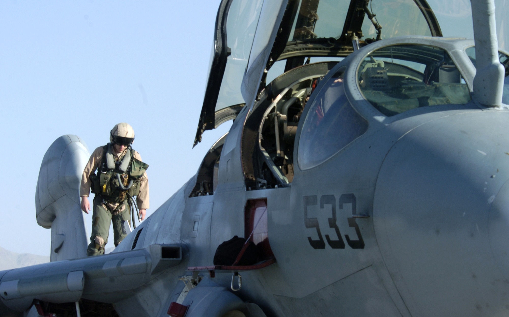 Air Force Capt. Matthew Polus walks on a Navy EA-6B Prowler and checks it before takeoff from Bagram Air Base, Afghanistan, on Thursday, June 15. Captain Polus is an electronic countermeasures officer with the Electronic Attack Squadron 133 Wizards. Air Force and Navy crewmembers fly the Prowler, providing support to ground troops in Afghanistan. (U.S. Air Force photo/Senior Airman Brian Ferguson)