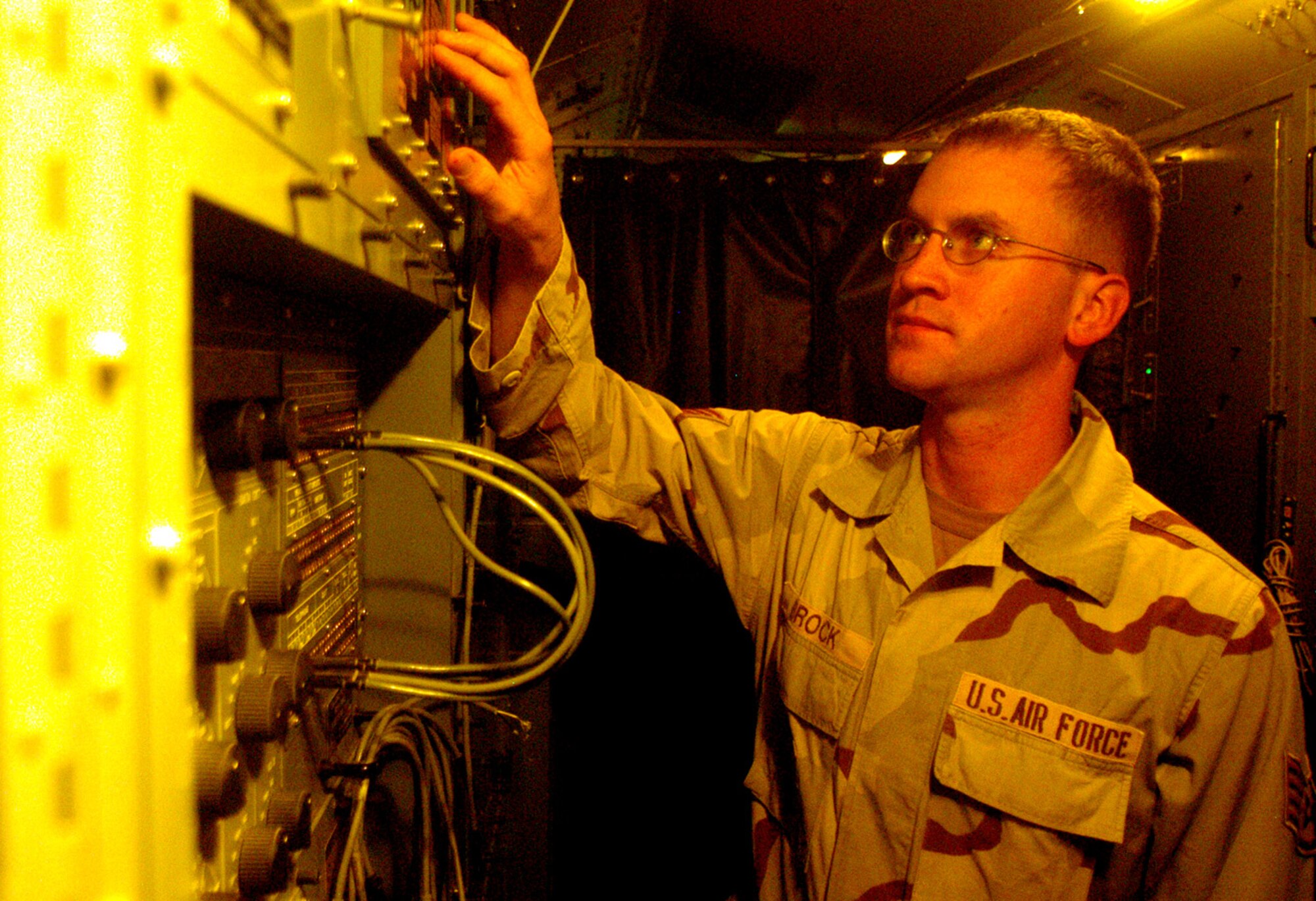 Staff Sgt. Kyle Brock makes adjustments in an operations module at the 73rd Expeditionary Air Control Squadron at Kandahar Airfield, Afghanistan, on Saturday, June 3. Sergeant Brock is a computer maintenance technician deployed from Spangdahlem Air Base, Germany. (U.S. Air Force photo/Maj. David Kurle)