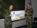 Staff Sgt. David Marshall, 305th Maintenance Squadron, accepts a $10,000 check from Col. Rick Martin, 305th Air Mobility Wing commander, for his money-saving idea.