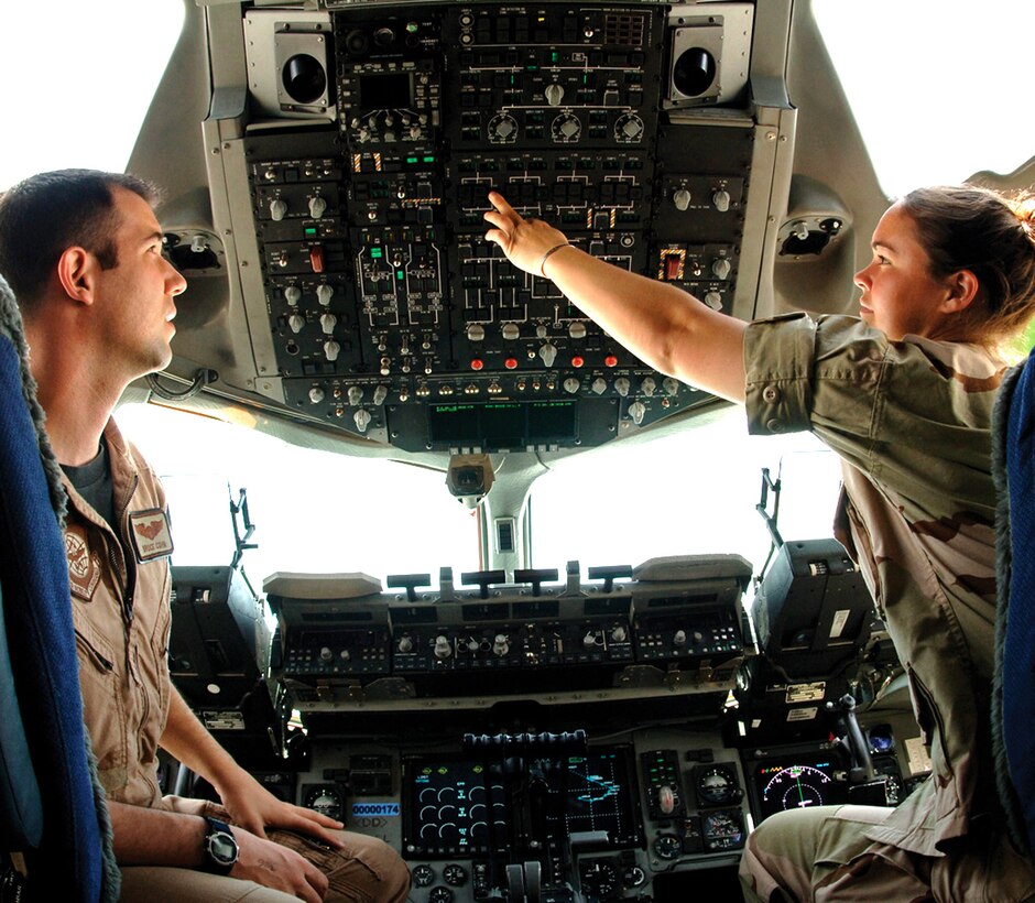 Cadet 1st Class Erica Olson, a senior at the U.S. Air Force Academy, goes over a C-17 Globemaster III instrument panel with Capt. Bruce Cohn on the flightline at a deployed location in Southwest Asia on Thursday, June 15. Cadet Olson is among 19 academy cadets deployed to Southwest Asia as part of Operation Air Force to gain an operational perspective. (U.S. Air Force photo/Senior Airman Tim Bazar)