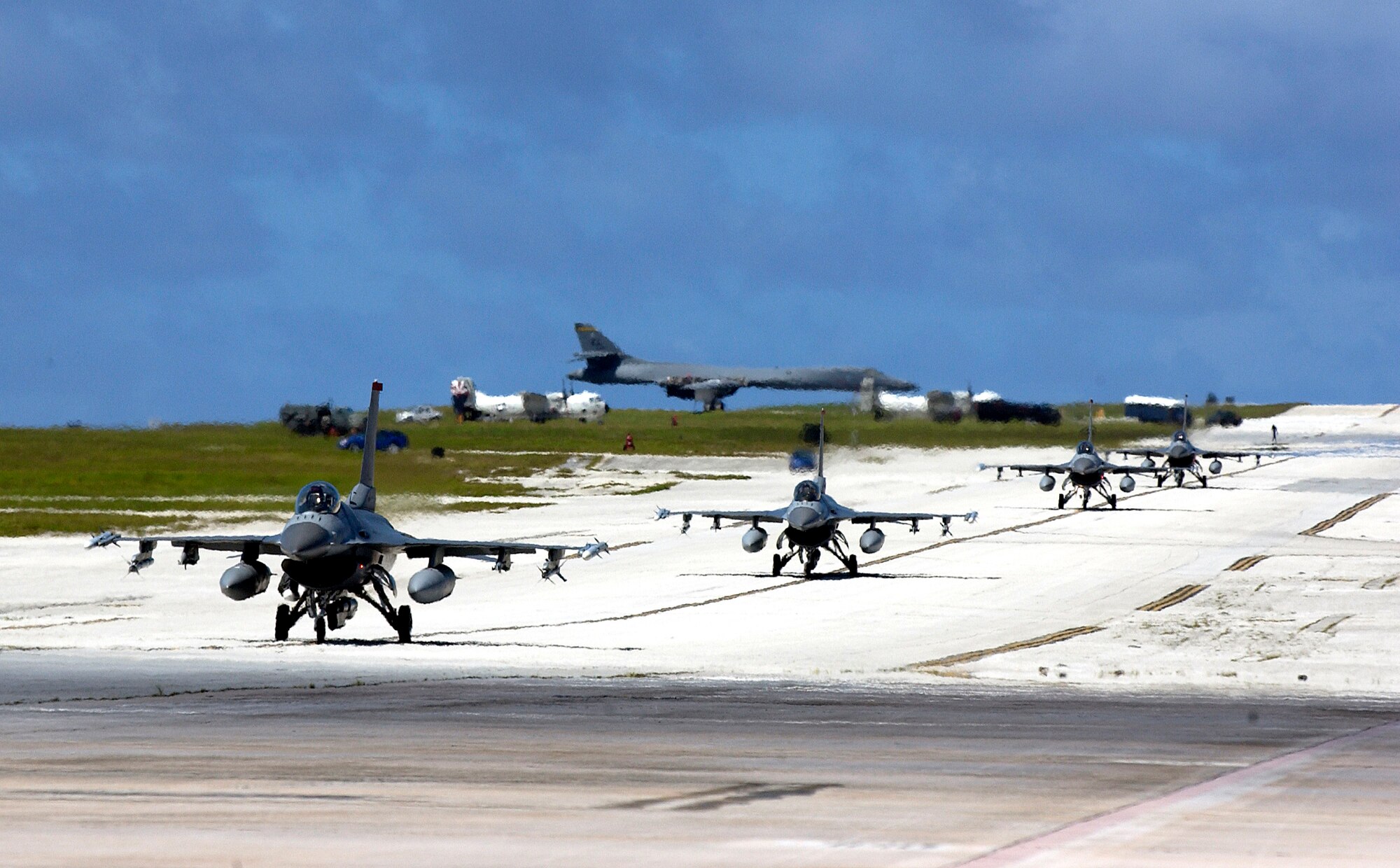 Four F-16 Fighting Falcons taxi at Andersen Air Force Base, Guam, on Monday, June 19, after a training mission for Exercise Valiant Shield 2006. Valiant Shield focuses on integrated joint training and interoperability among U.S. military forces while responding to a range of mission scenarios. The F-16s are with the 13th Fighter Squadron at Misawa Air Base, Japan. (U.S. Air Force photo/Airman 1st Class Michael S. Dorus)