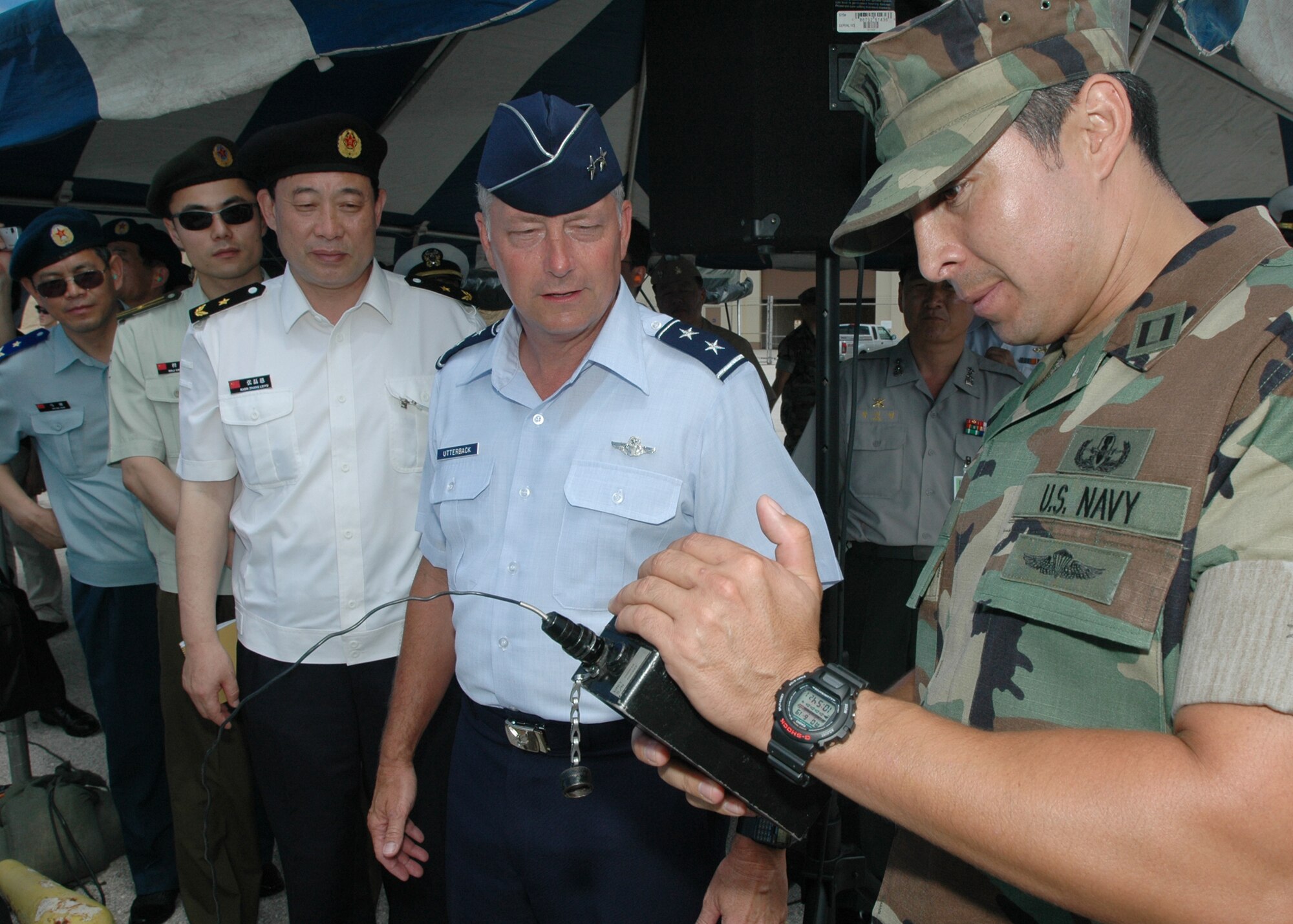 Santa Rita, Guam (June 19, 2006) – Lt. Oscar Rojas, Operations Officer, Explosive Ordinance Disposal Mobile Unit Five explains the functions of a remote detonator to Maj. Gen Loyd Utterback, USAF Deputy Commander, Joint Task Force 519 and Rear Adm. Zhang Leiyu from the People’s Republic of China before detonation of ordnance that was placed within Apra Harbor by EODMU Five.  Dignitaries from Australia, China, India, Japan, Korea, Russia and Singapore were present during this demonstration. The group also observed demonstrations by Naval Special Warfare Unit One and Mobile Security Squadron Seven during their tour.  The thirty three foreign dignitaries are currently here to observe the U.S. Pacific Command exercise Valiant Shield 2006 which involves approximately 22,000 Sailors, Airmen, Marines, Soldiers and Coast Guardsmen, one of the largest joint-military exercises in the Pacific in more than a decade. (U.S. Navy photo by PH2 (AW) John F. Looney)