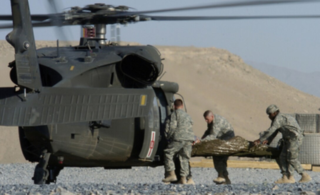 U.S. Army soldiers load a patient into a UH-60 Black Hawk helicopter during a medical evacuation mission in Qalat, Afghanistan, on June 13, 2006. 