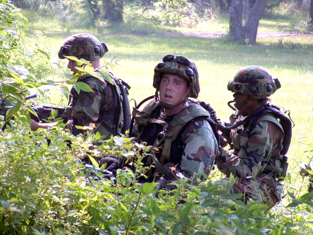 Airmen attending the Air Force Integrated Contingency Skills Training Course 06-4 at Fort Dix, N.J., respond to a scenario in combat patrol and tactics on Monday, June 19. More than 165 students are participating in the two-week training to prepare for deployments. The course is taught by instructors from the Air Mobility Warfare Center's 421st Combat Training Squadron. (U.S. Air Force photo/Tech. Sgt. Scott T. Sturkol)