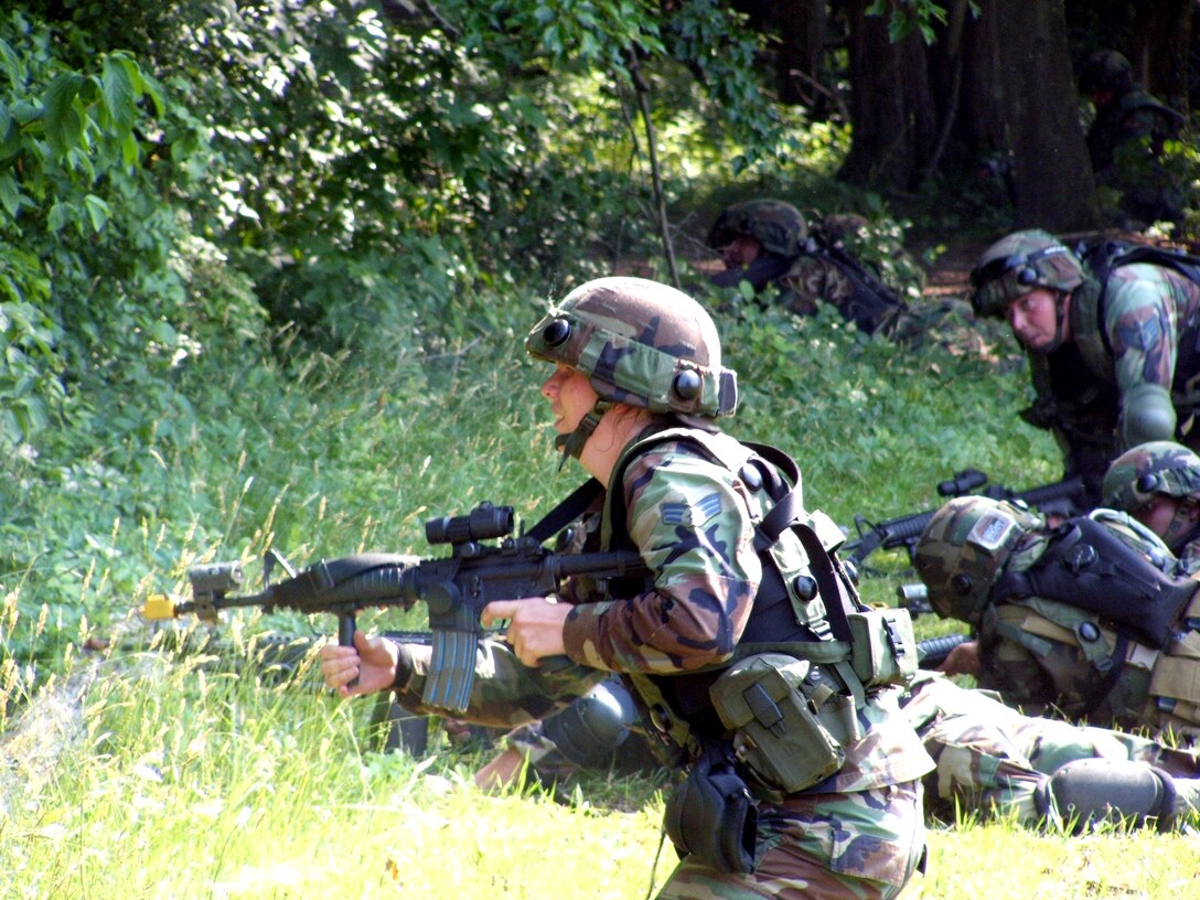 Senior Airman Karyn Chalifoux responds to a scenario during combat patrol and tactics training at Fort Dix, N.J., on Monday, June 19. More than 165 students are participating in Air Force Integrated Contingency Skills Training Course 06-4. Airmen participating in the two-week training are preparing for deployments. The course is taught by instructors from the Air Mobility Warfare Center's 421st Combat Training Squadron. Airman Chalifoux is assigned to the 6th Security Forces Squadron at MacDill Air Force Base, Fla. (U.S. Air Force photo/Tech. Sgt. Scott T. Sturkol)