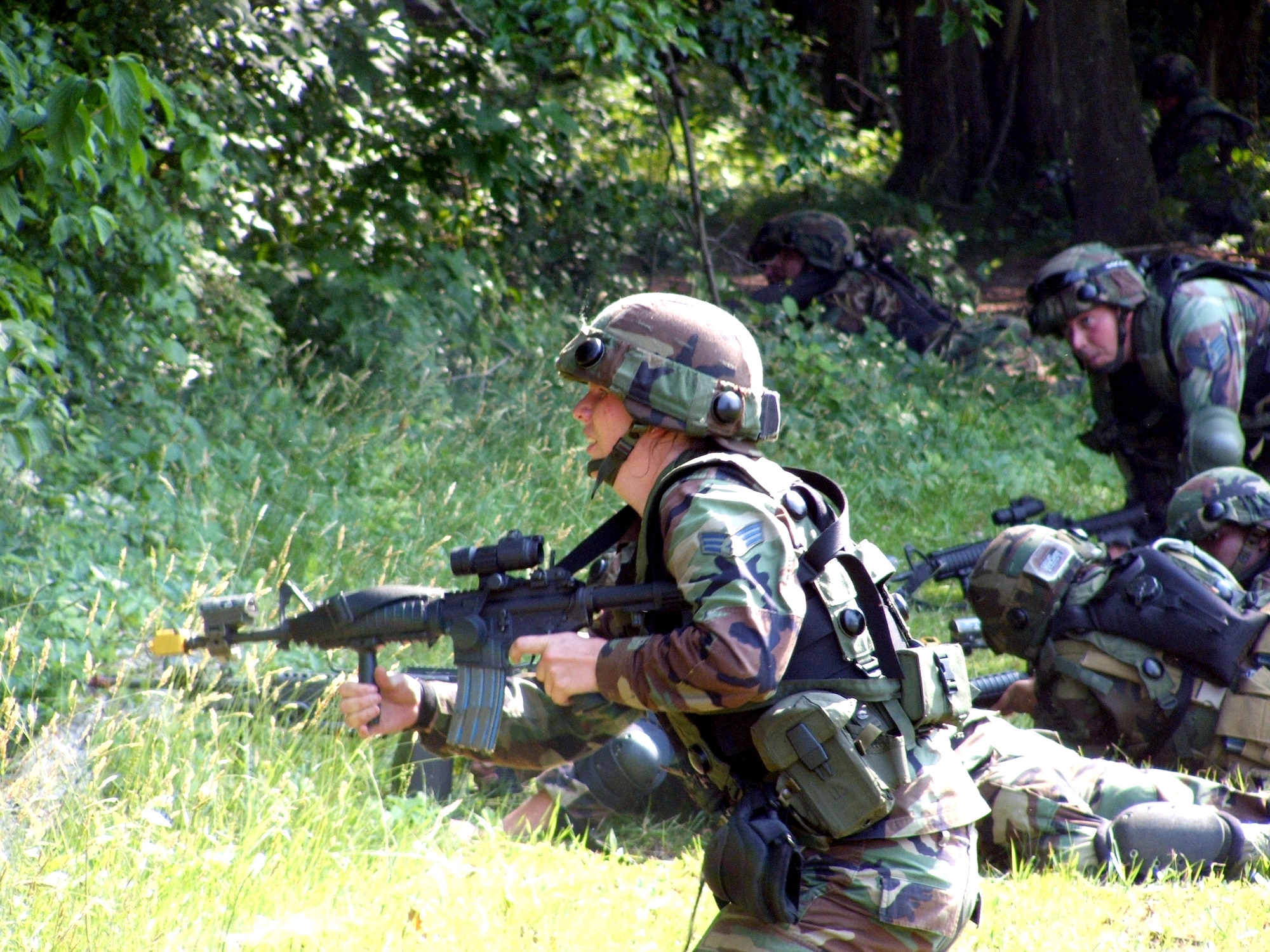 Senior Airman Karyn Chalifoux responds to a scenario during combat patrol and tactics training at Fort Dix, N.J., on Monday, June 19. More than 165 students are participating in Air Force Integrated Contingency Skills Training Course 06-4. Airmen participating in the two-week training are preparing for deployments. The course is taught by instructors from the Air Mobility Warfare Center's 421st Combat Training Squadron. Airman Chalifoux is assigned to the 6th Security Forces Squadron at MacDill Air Force Base, Fla. (U.S. Air Force photo/Tech. Sgt. Scott T. Sturkol)
