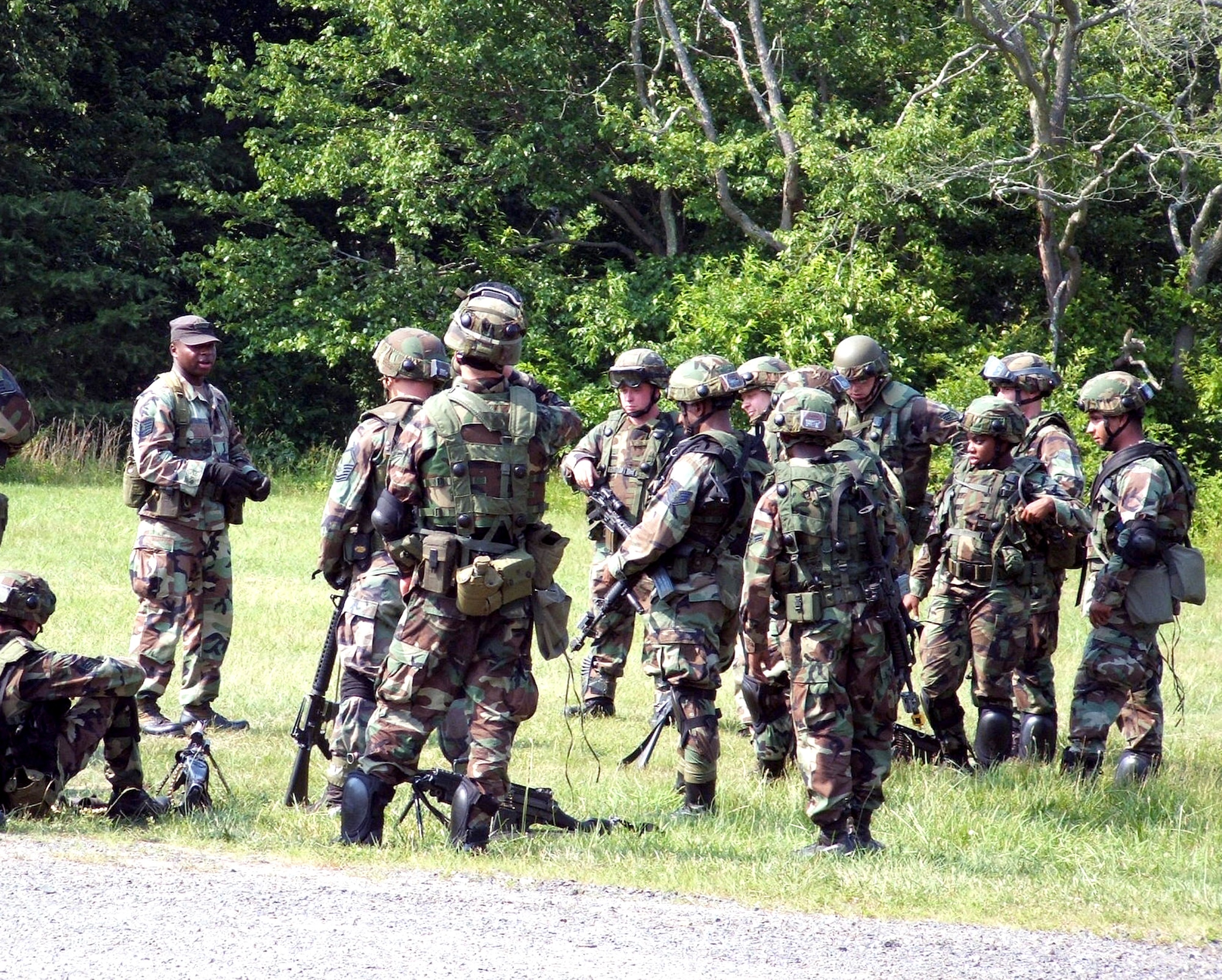 Staff Sgt. Shaylin Butler (left) talks to students about combat patrolling and tactics during a field session at the Air Force Integrated Contingency Skills Training Course 06-4 at Fort Dix, N.J., on Monday, June 19. More than 165 students are participating in the two-week course. Airmen in the training are preparing for deployments. Sergeant Butler is an instructor for the Air Mobility Warfare Center's 421st Combat Training Squadron, which manages the course. (U.S. Air Force photo/Tech. Sgt. Scott T. Sturkol)
