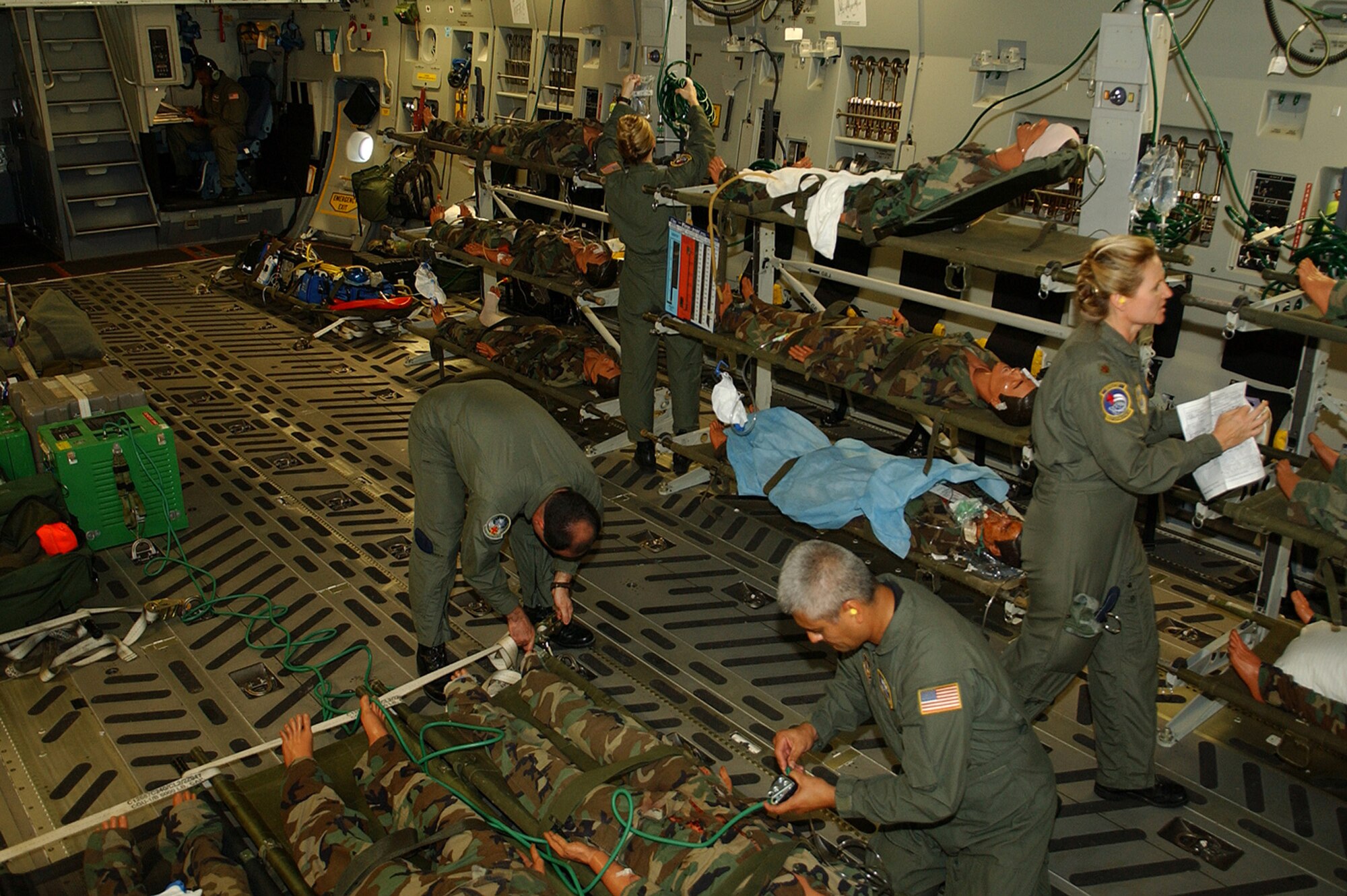 Aeromedical evacuation crews aboard a c-17 prepare patients for airlift June 17 from the mobile aeromedical staging facility to the contingency aeromedical staging facility at Augusta Regional Airport at Busch Field, Ga., one of the locations of Golden Medic 2006, an annual training medical exercise.  (U.S. Air Force photo/Staff Sgt. Stephen Schester)