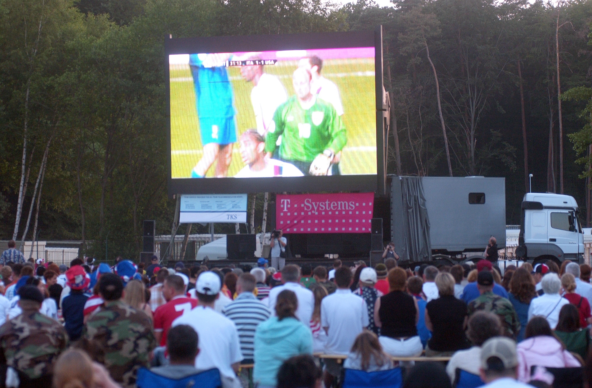 Servicemembers and their families watch the U.S.A. vs. Italy World Cup soccer match at the World Cup Fest at Pulaski Park in Kaiserslautern, Germany, on Saturday, June 17. The game ended in a 1-1 tie, keeping U.S. hopes alive in the 2006 FIFA World Cup. (U.S. Army photo/Christine June) 
