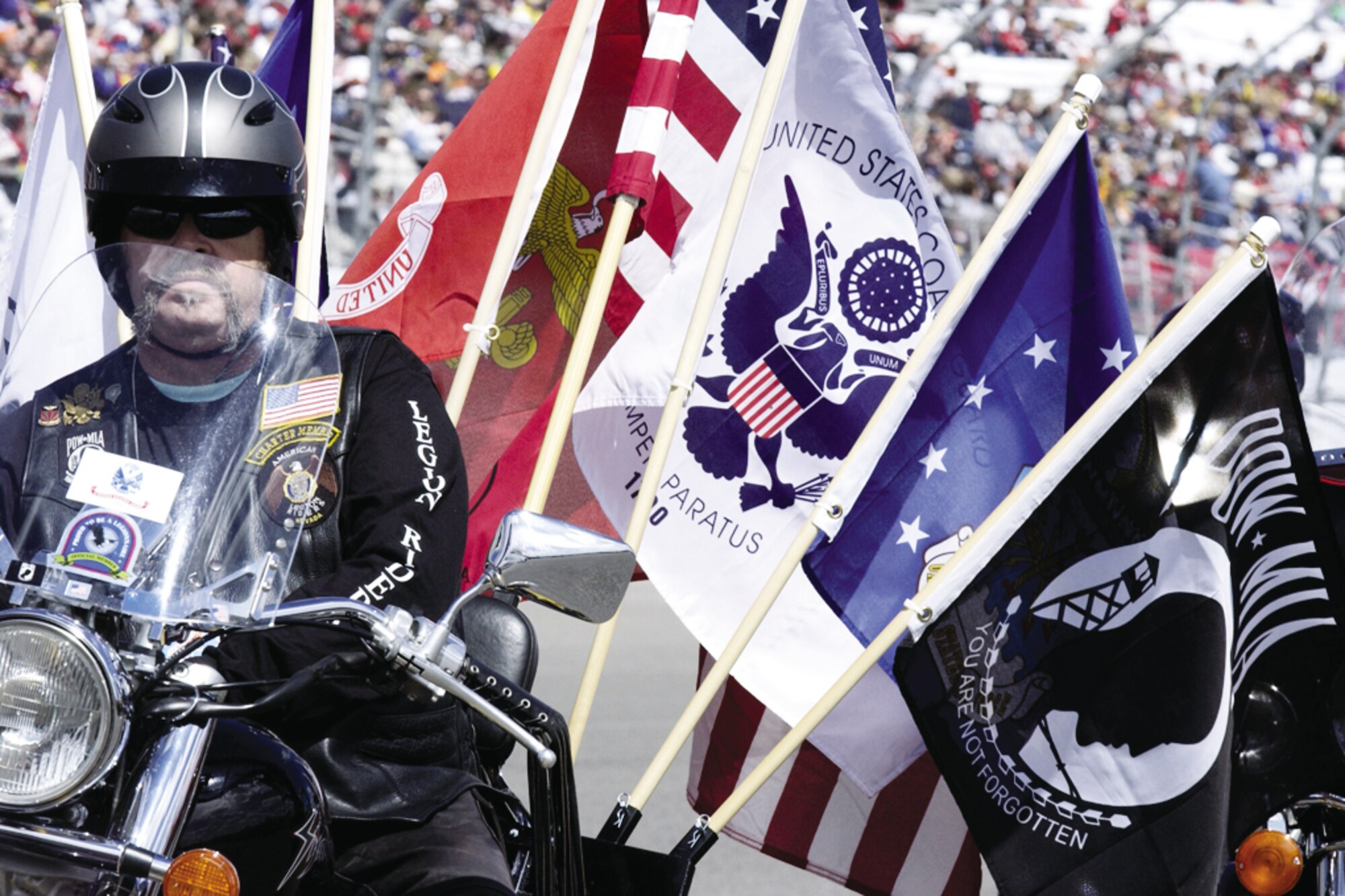 An American Legion Riders Group member makes an entrance on his Harley-Davidson during the opening ceremonies for theUAW-Daimler Chrysler 400 Nextel Cup race March 12, 2006, at the Las Vegas Motor Speedway. (U.S. Air Force photo/ Master Sgt. Kevin J. Gruenwald)
