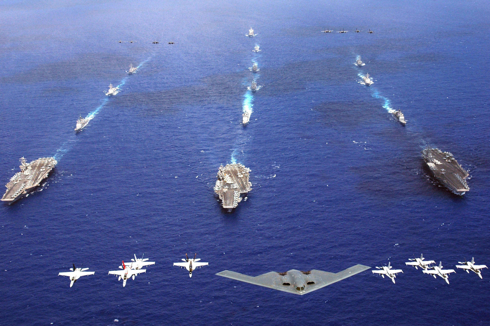 A B-2 Spirit and 16 other aircraft from the Air Force, Navy and Marine Corps fly over the USS Kitty Hawk, USS Ronald Reagan and USS Abraham Lincoln carrier strike groups in the western Pacific Ocean on Sunday, June 18, to kick off Exercise Valiant Shield 2006. The joint exercise consists of 28 naval vessels, more than 300 aircraft and approximately 20,000 servicemembers. (U.S. Navy photo/Chief Photographer's Mate Todd P. Cichonowicz)
