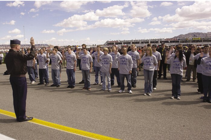 Brig. Gen. Robertus Remkes, Air Force Recruiting Service commander, Randolph AFB, Texas, delivers the oath of enlistment to 24 Air Force delayed entry members at the Las Vegas Motor Speedway during the opening ceremonies for the  UAW-Daimler Chrylser 400 race March 12, 2006. (U.S. Air Force photo/Airman Nadine Y. Barclay) 
                               
