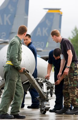 ELMENDORF AFB, Alaska -- Crew chiefs with the 12th Aircraft Maintenance Unit here secure an F-15 fuel tank after reconfiguration of its fuel quantity during Northern Edge.
This annual exercise, which concludes June 16, is one of a series of U.S. Pacific Command exercises in 2006 that prepares joint forces to respond to crises in the Asian Pacific region.  
(U.S. Air Force Photo by Senior Airman Garrett Hothan) (RELEASED)