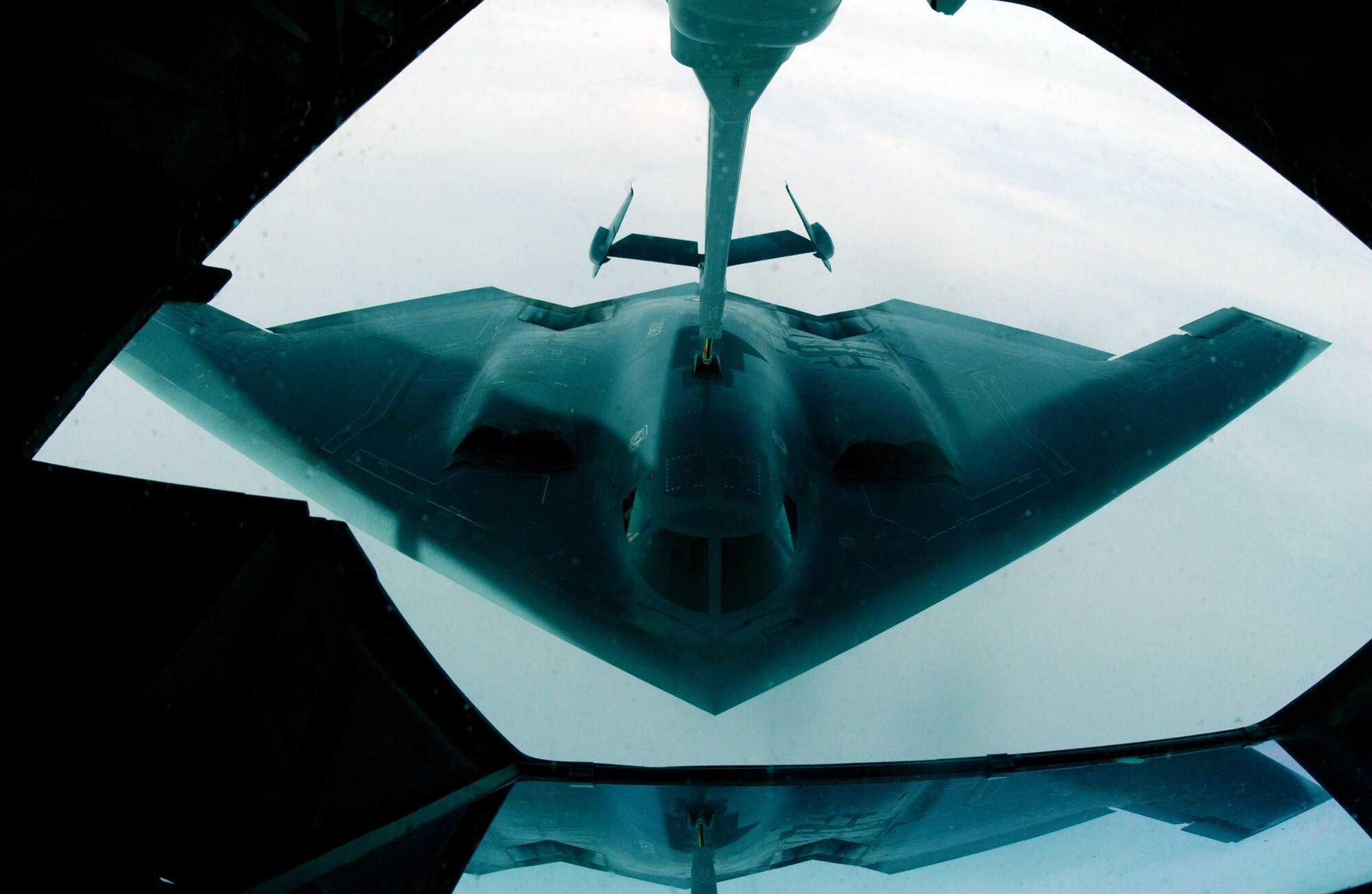 A B-2 Spirit bomber from the 393rd Expeditionary Bomb Squadron at Andersen Air Force Base, Guam, is refueled by a KC-10 Extender on Thursday, June 8, during Exercise Northern Edge 2006. B-2 pilots left Guam, completed a sortie at a training range approximately 4,500 nautical miles away in Alaska, and returned -- a 9,800 nautical-mile round trip lasting more than 24 hours. (U.S. Air Force photo/Staff Sgt. Joshua Strang)
