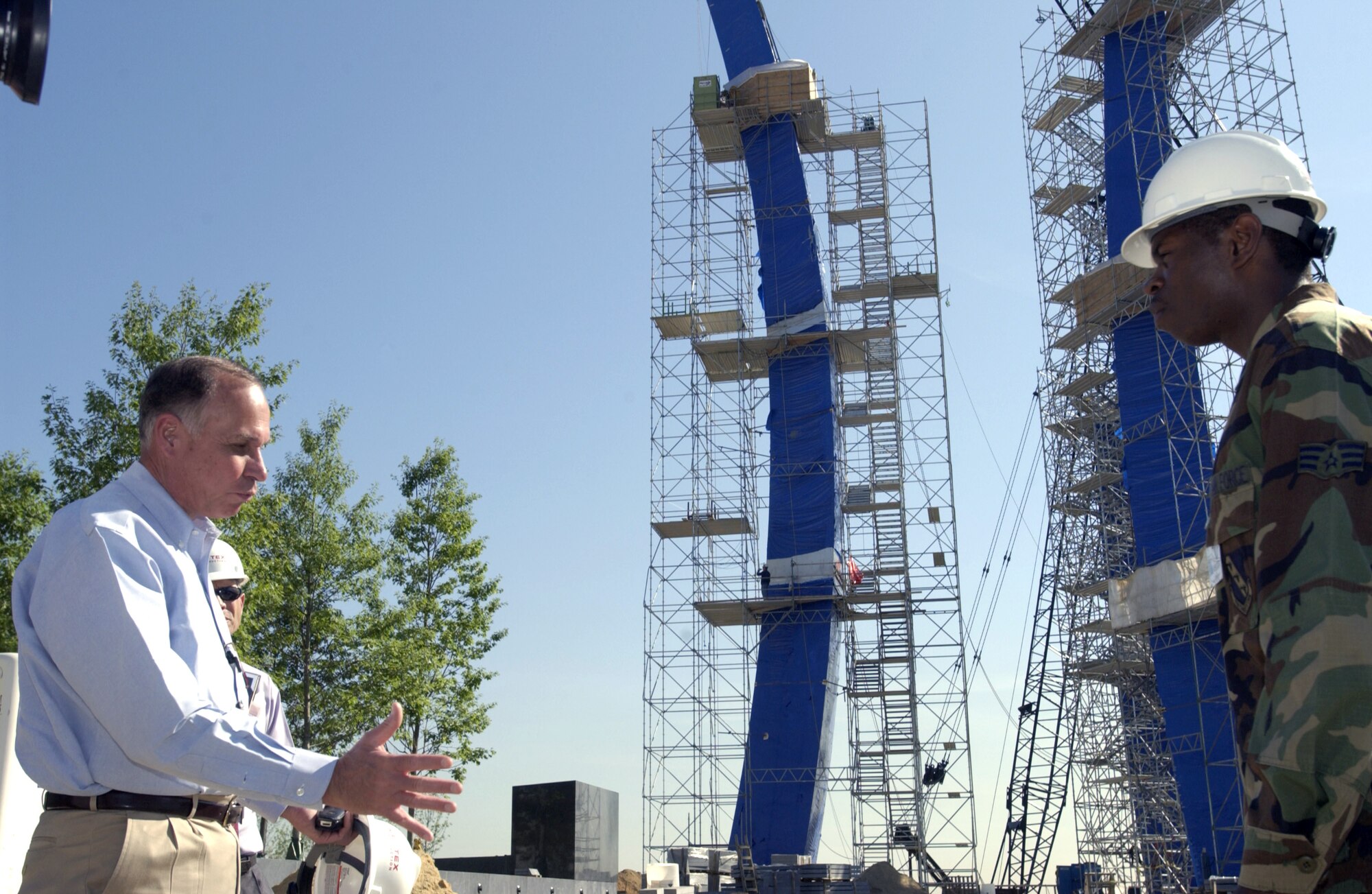 Retired Maj. Gen. Edward F. Grillo Jr. talks with Senior Airman Henry Hargrove about the importance of the new Air Force Memorial and what it will mean to past, present and future Airmen. The memorial is scheduled to be completed in October. Its three spires represent the Air Force core values. General Grillo is president of the Air Force Memorial Foundation. Airman Hargrove is assigned to the 11th Logistics Readiness Squadron at Bolling Air Force Base in Washington, D. C. (U.S. Air Force photo/Tech. Sgt. Cohen A. Young) 
